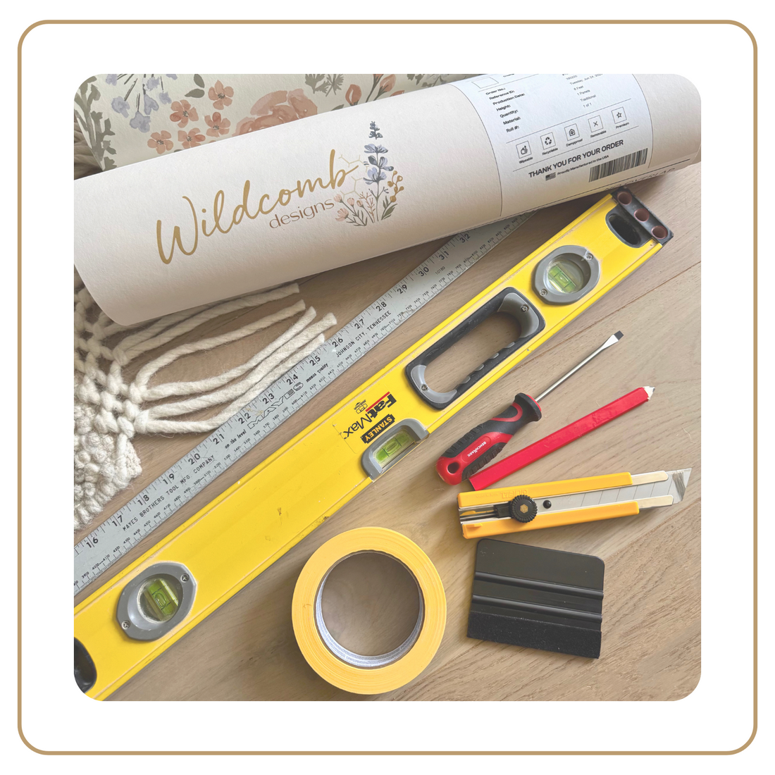 Tools and materials for wall art creation on a wooden surface with 'Wildcomb designs' branding.