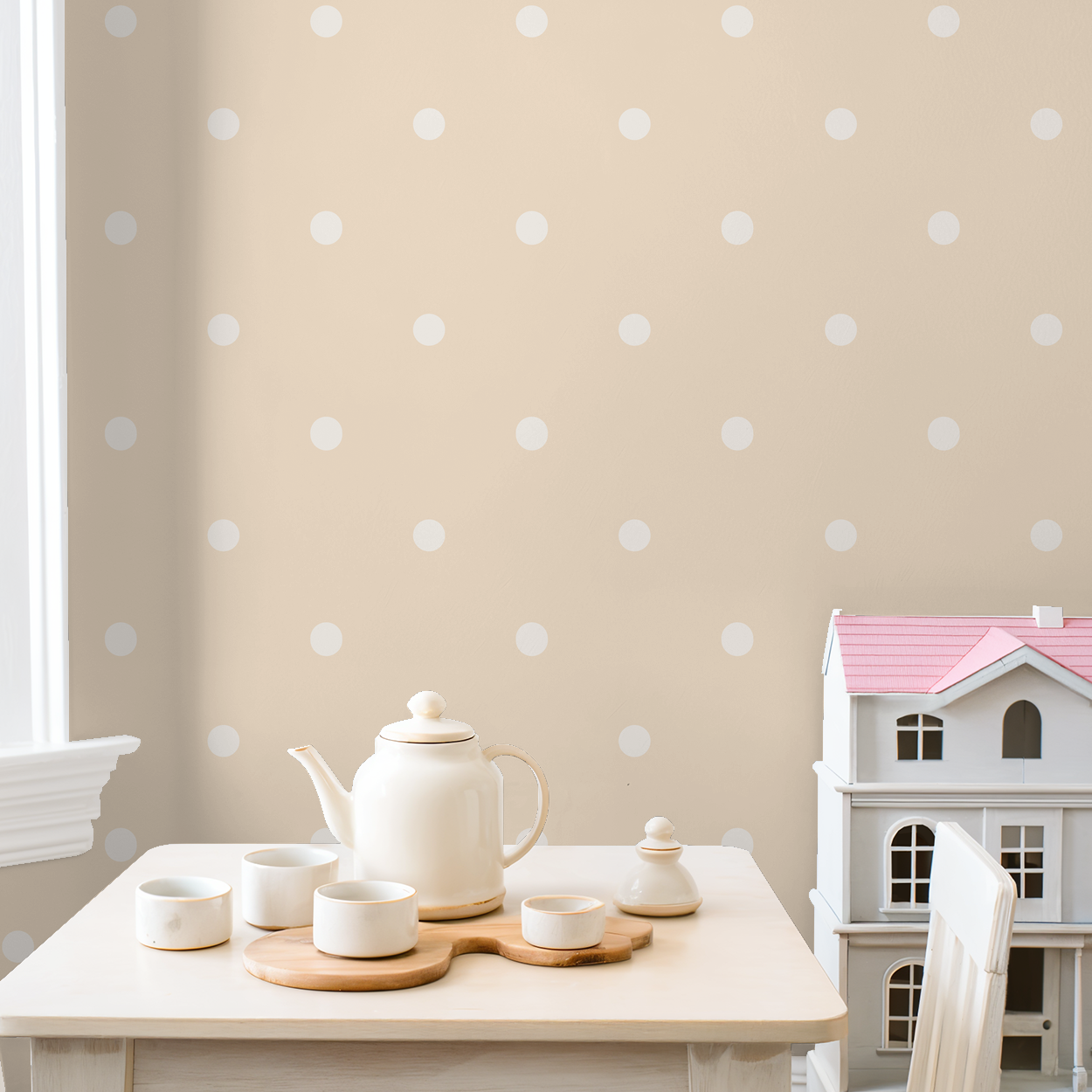 Peach polka dot wallpaper in cozy room with tea set and dollhouse.