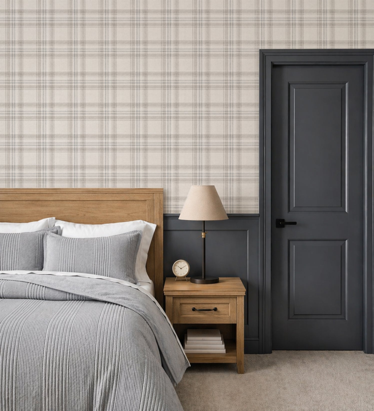 Teen bedroom with neutral plaid wallpaper, dark accent door, and layered gray bedding in a modern, elevated interior.