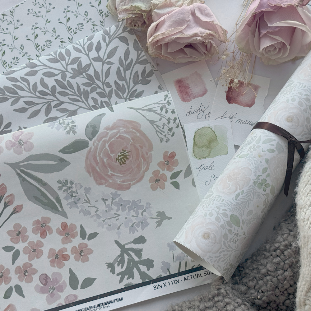 Soft blush floral nursery wallpaper sample featuring hand-drawn pink roses, delicate wildflowers, and sage green botanical accents in muted watercolor tones — a romantic custom nursery décor option perfect for a baby girl’s room, personalized kids’ wall art styling, and elegant children’s bedroom design.