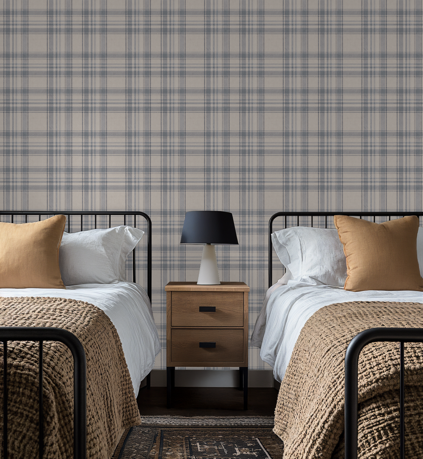 Two beds with Tweed Plaid - Navy Blues wallpaper and a nightstand in the center.