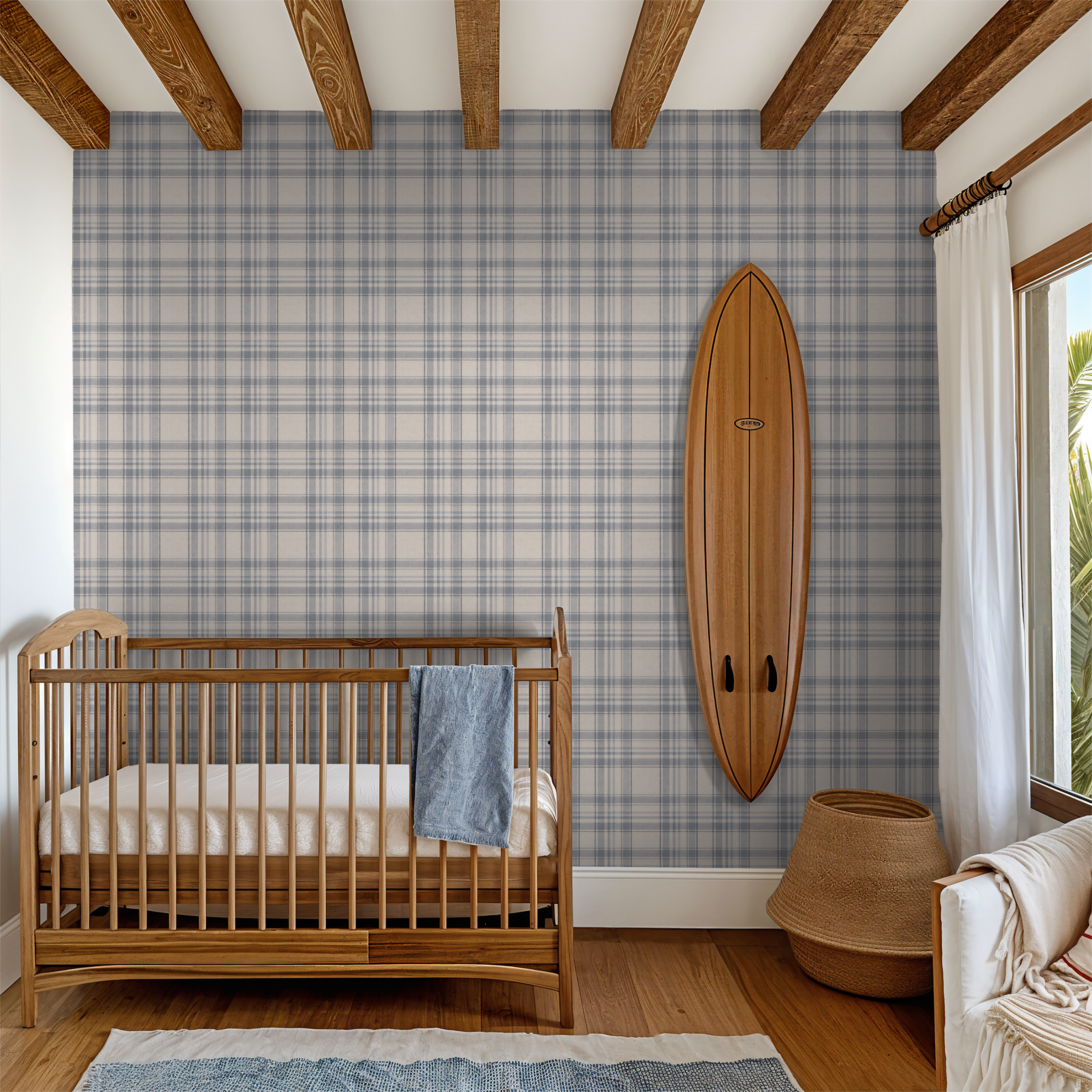 Nursery room with wooden crib, Tweed Plaid - Navy Blues wallpaper, and surfboard decor.