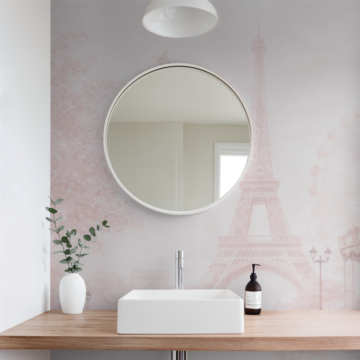 Bathroom with round mirror, sink, and Parisian Dreamscape wallpaper.