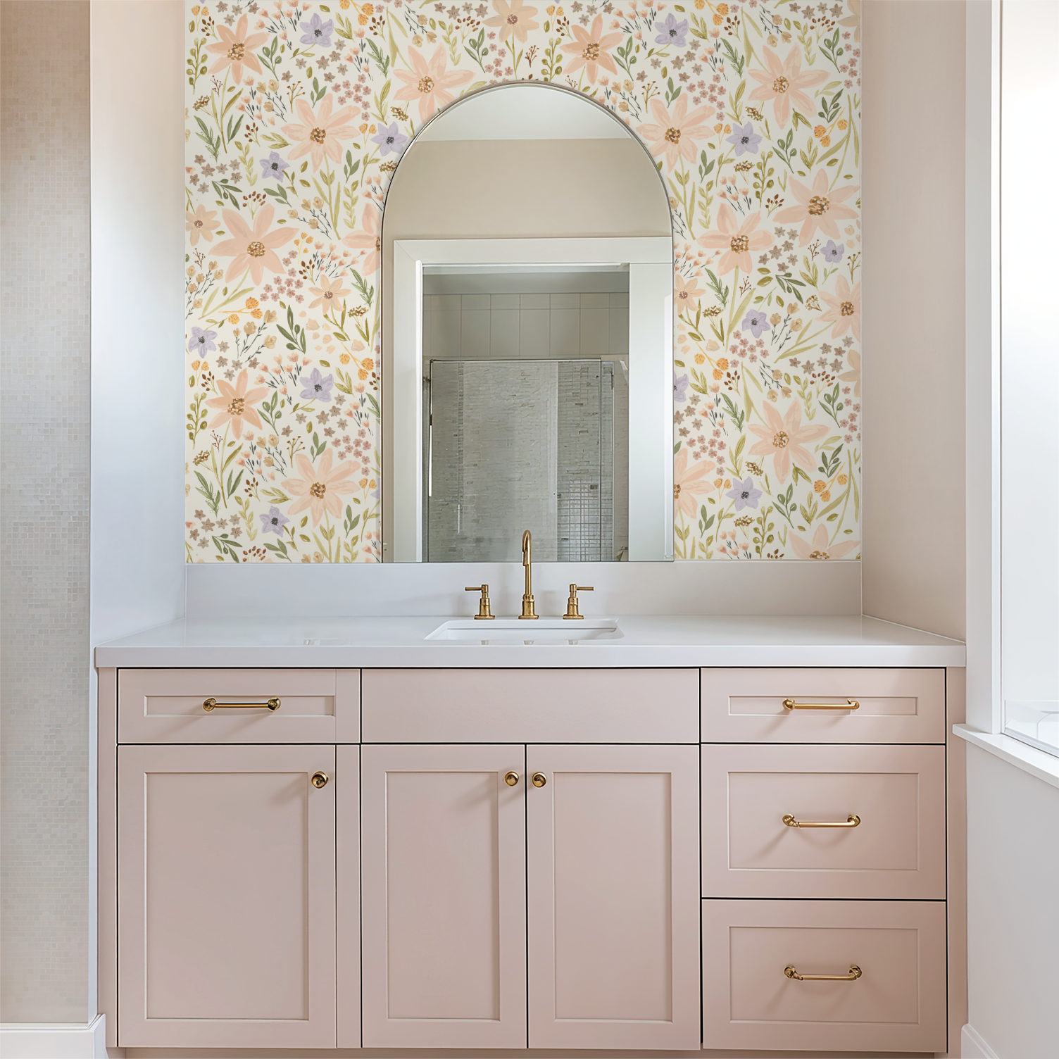 Bathroom vanity with floral wallpaper, mirror, and white countertop.