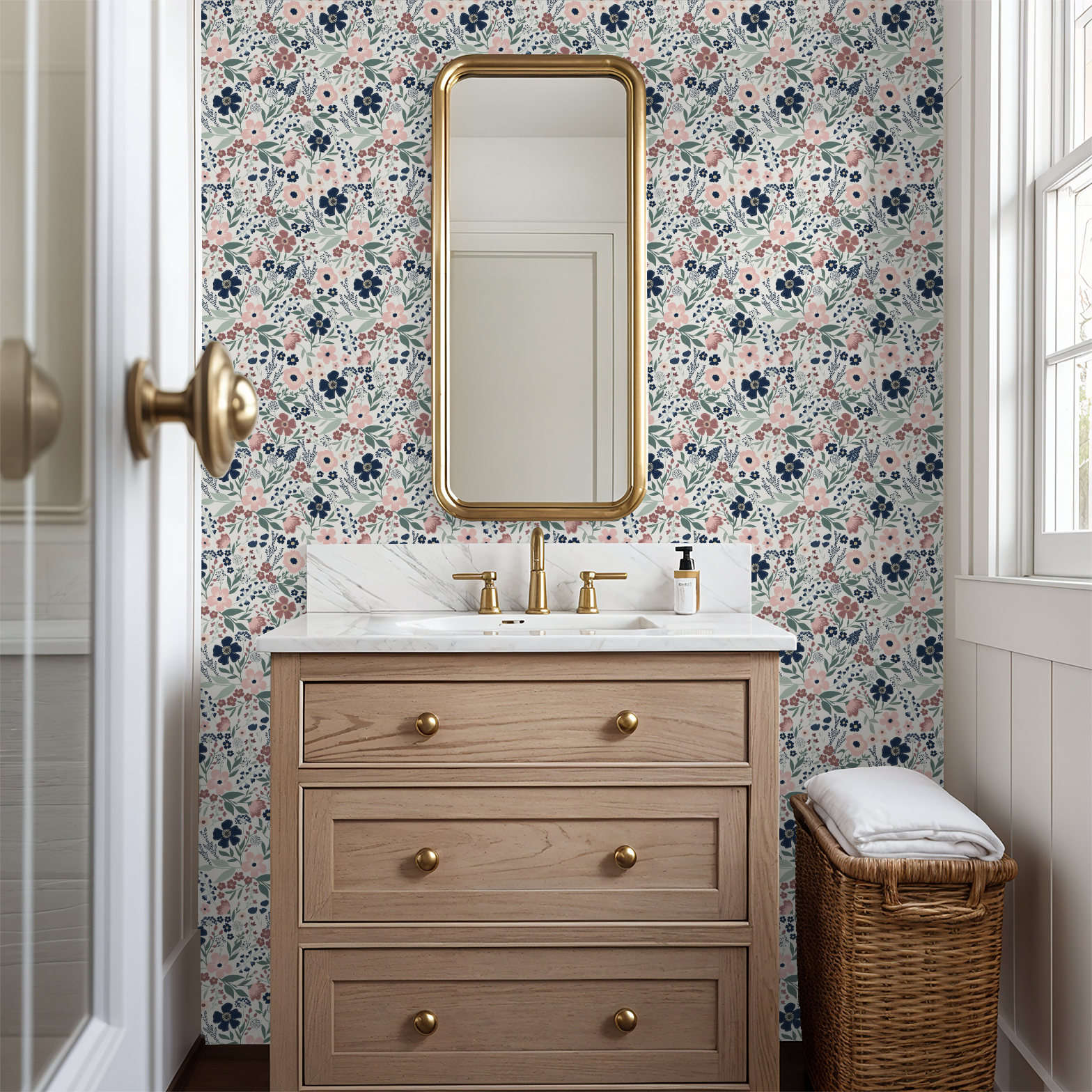 Navy and mauve floral wallpaper featured in a bathroom with a light wood vanity, gold hardware, and a tall framed mirror