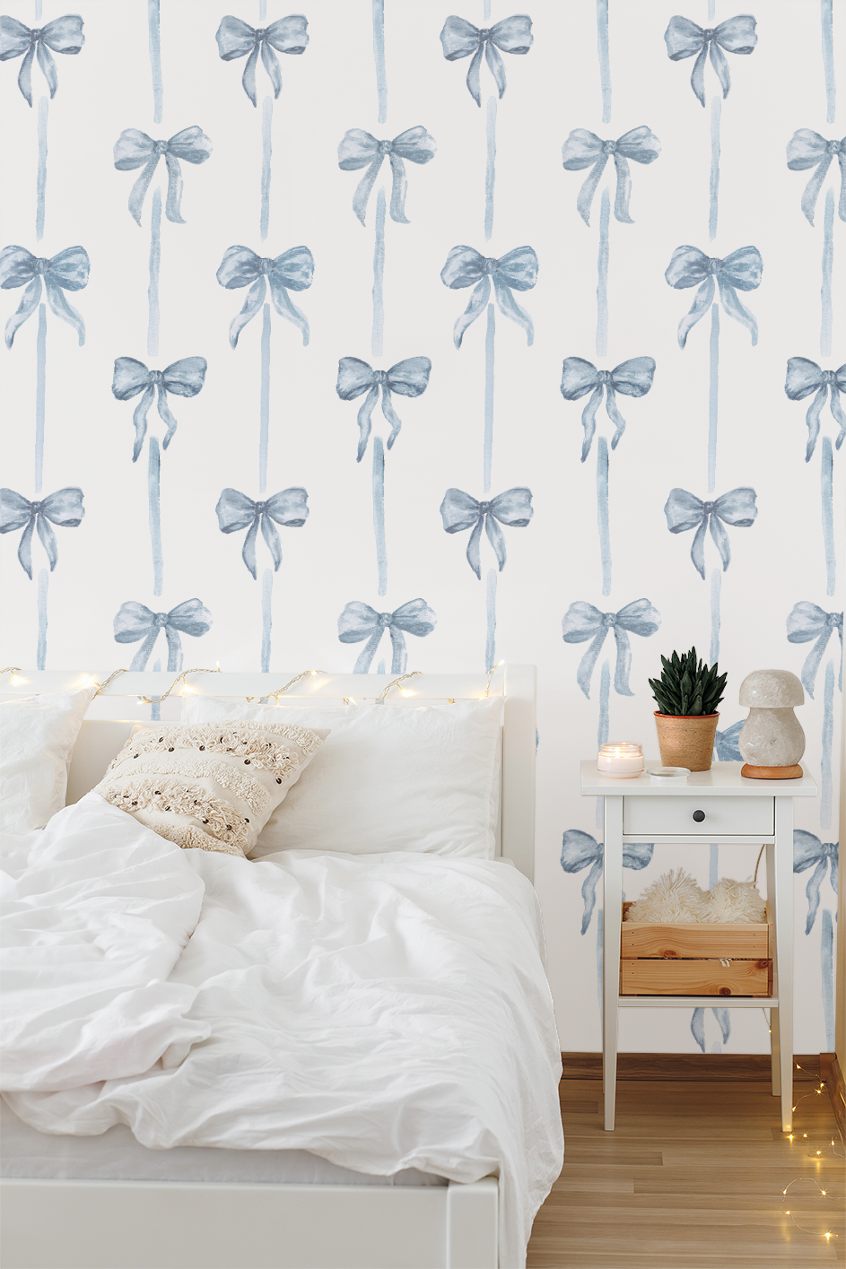Room interior with a bed and side table against a wall with decorative blue bow pattern.