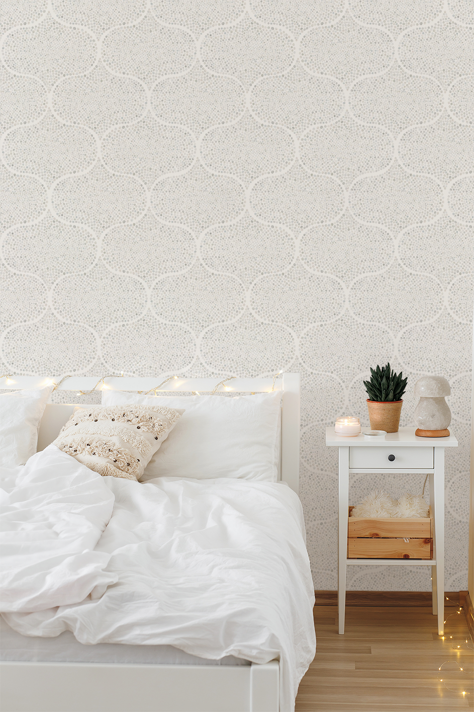 Bedroom with white bedding, nightstand, and wall with geometric pattern