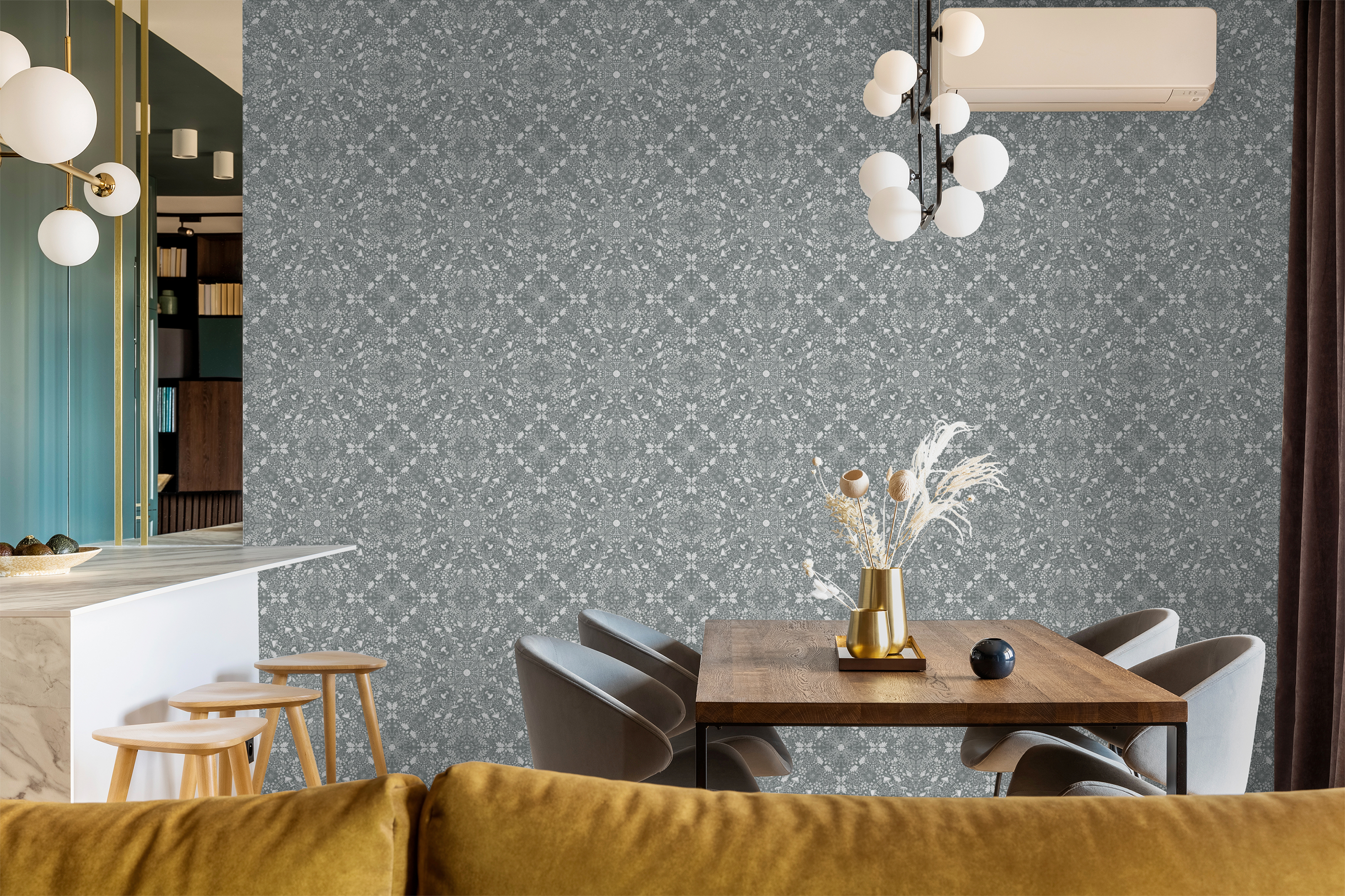 Modern dining area with navy Woodland Lace wallpaper, warm wood furniture, and a mustard velvet sofa in the foreground.