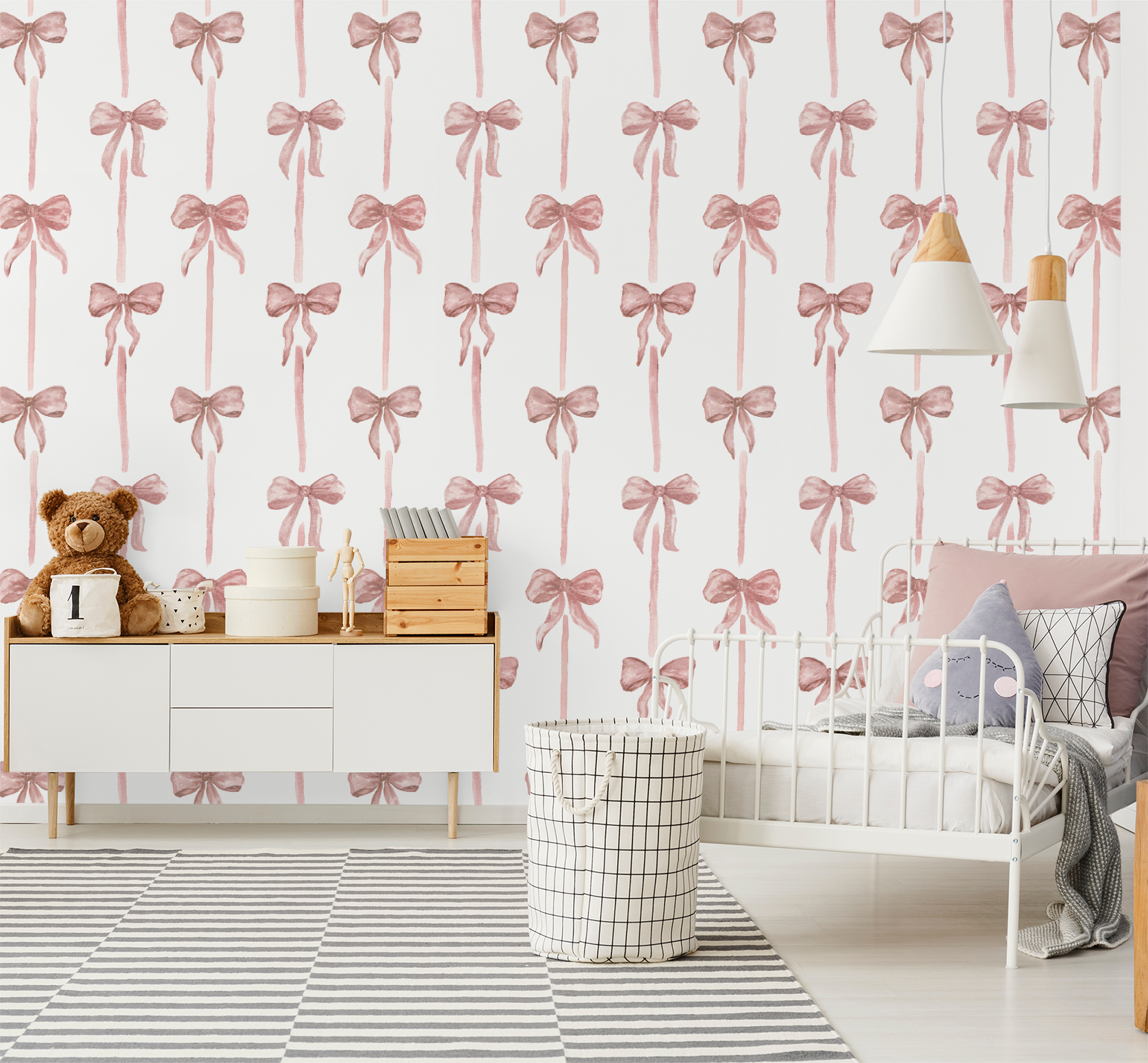 Children's room with pink bow patterned wallpaper, teddy bear, and white furniture.