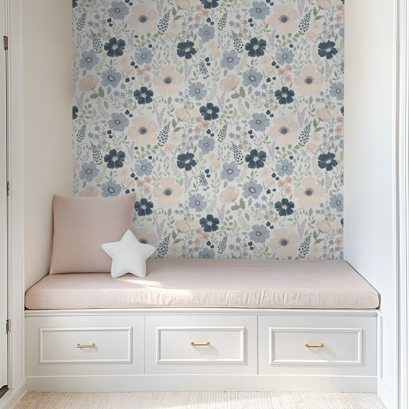 Navy and blush floral wallpaper framing a built-in reading nook with blush cushions and white drawer storage.