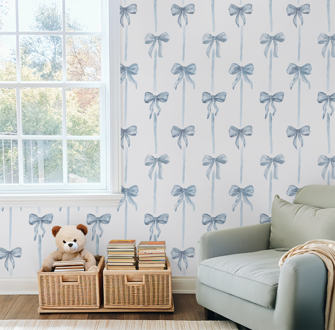 Living room with light blue bow-patterned wallpaper, a teddy bear, books, and a sofa.