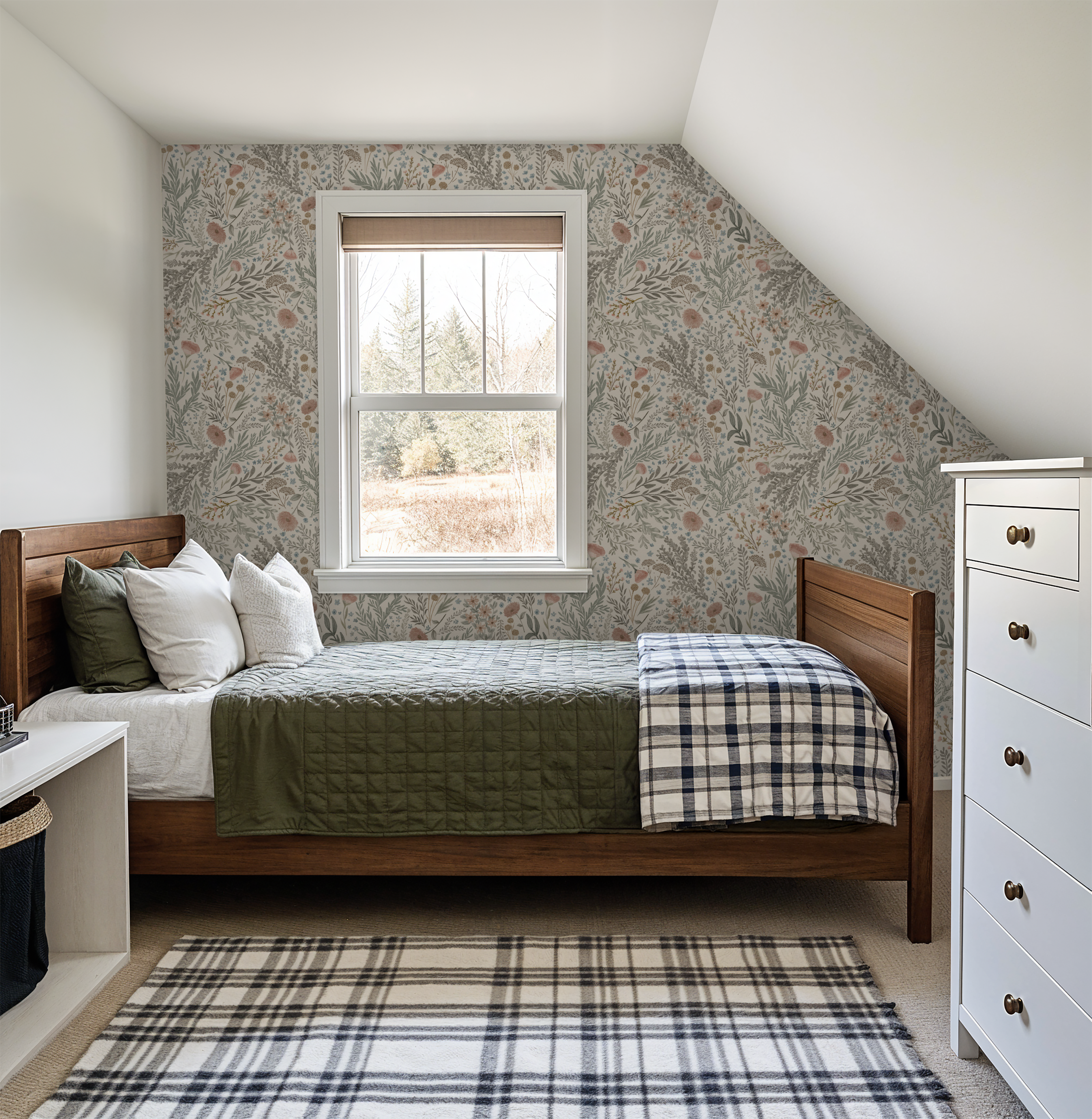 Bronte Woodland Fauna Floral wallpaper in an attic bedroom, styled with warm wood furniture, green quilted bedding, and a soft cottage-inspired palette.