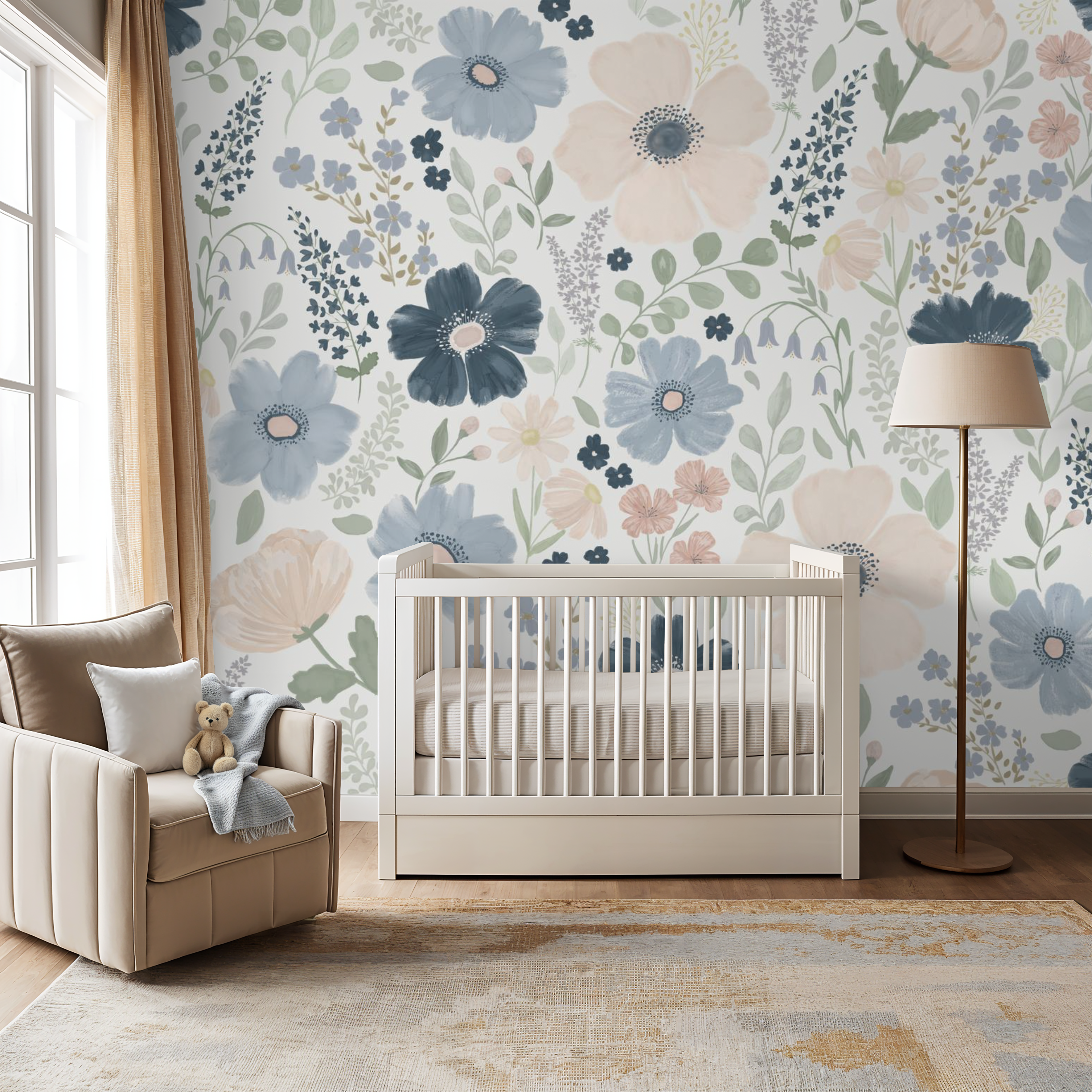 Oversized navy and blush flower mural wallpaper in warm neutral nursery with beige armchair and wooden crib.