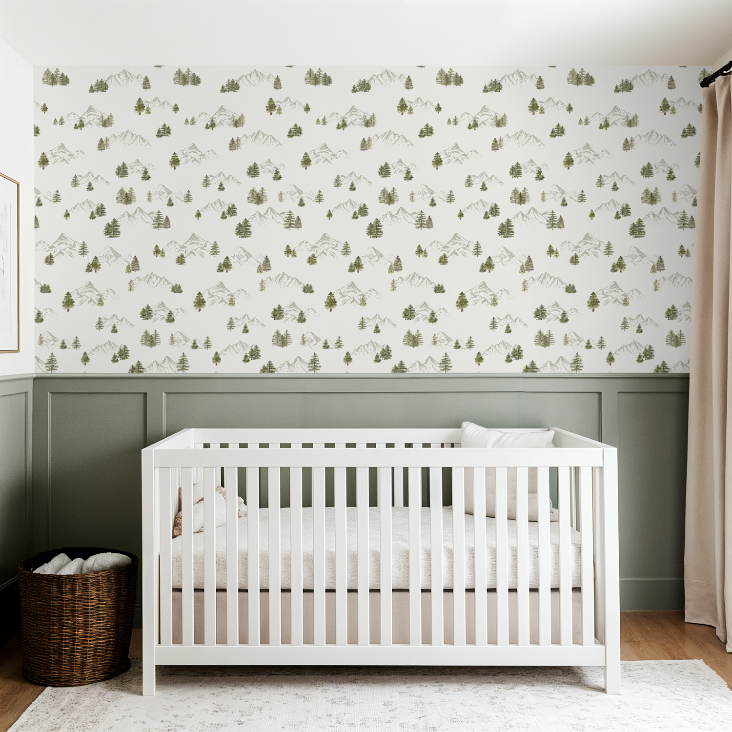 White crib in a room with tree mountain wallpaper, green paneling  and wooden flooring.