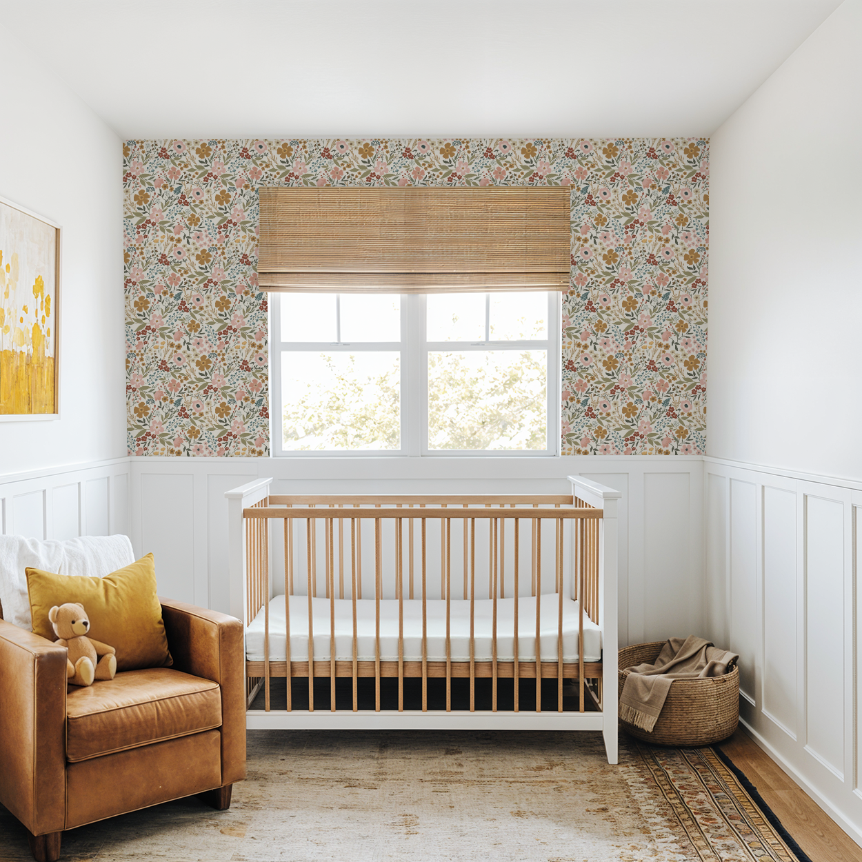 Nursery room with wooden crib, brown armchair, and floral wallpaper.