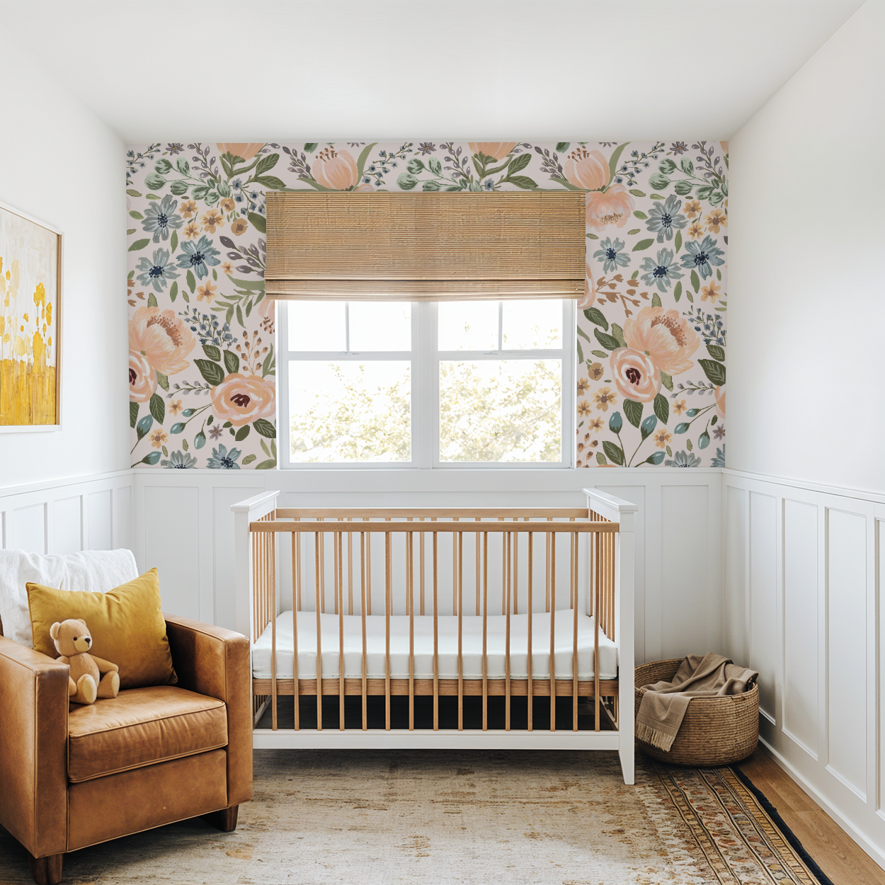 Neutral nursery with wainscoting and a natural wood crib framed by Juliette’s Summer Blooms wallpaper panels, highlighting oversized painterly flowers in summer tones.