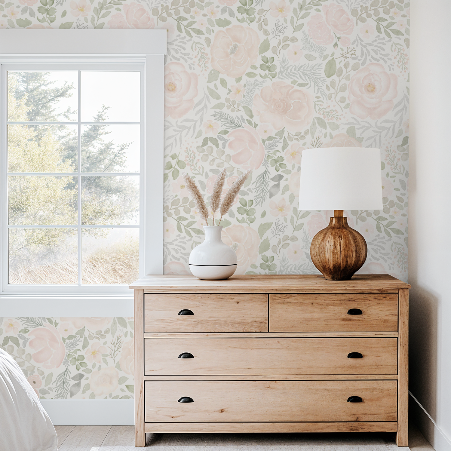 Wooden dresser with decorative items against a floral wallpapered wall.