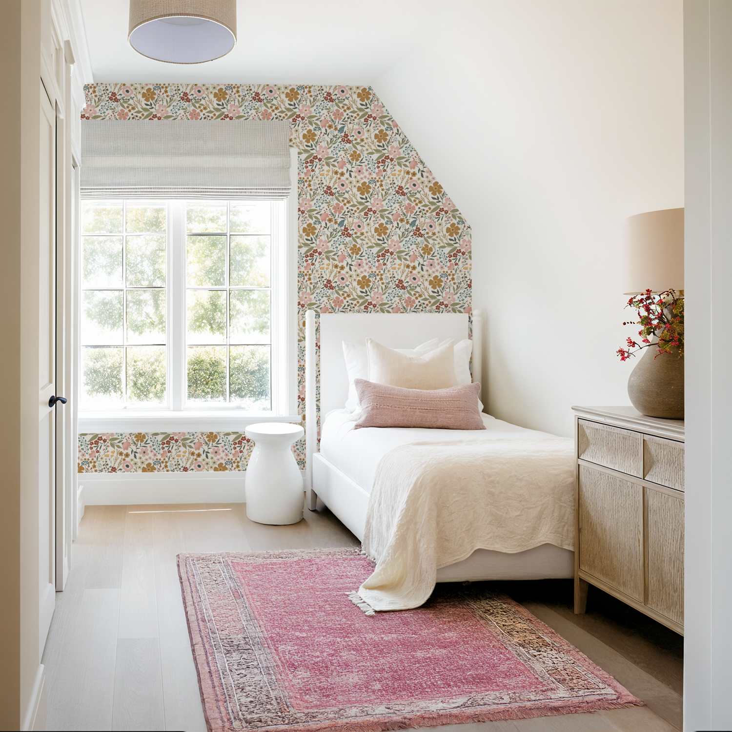 Neatly decorated bedroom with floral wallpaper, white bed, and pink rug.