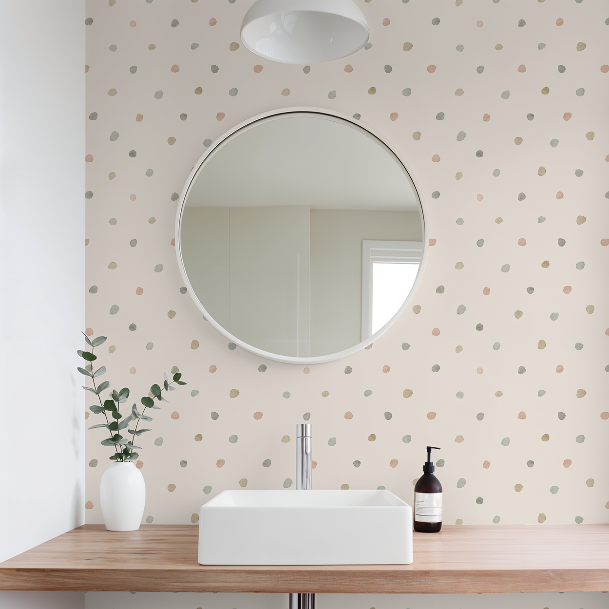 Bathroom with round mirror, sink, and polka dot wallpaper