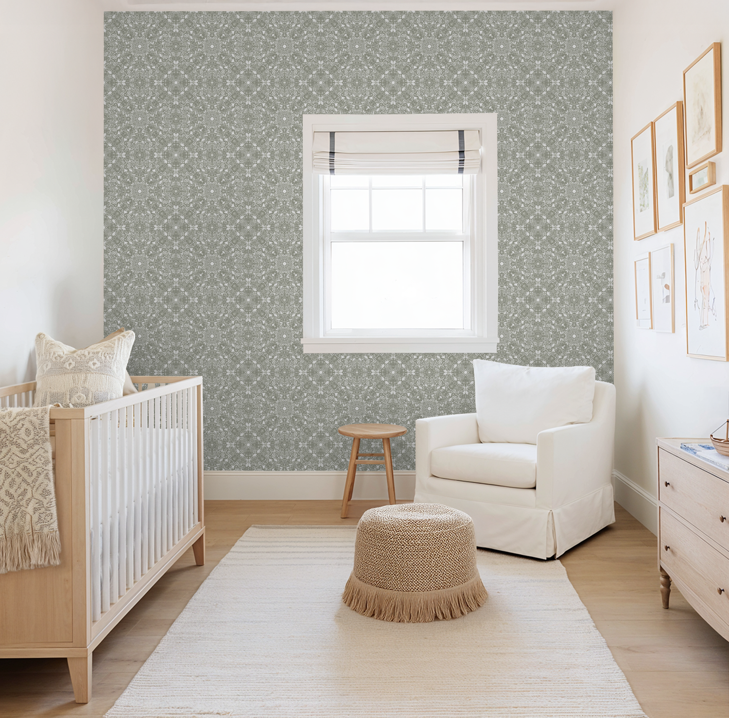 Nursery room with crib, armchair, and Woodland Lace in Sage wallpaper.