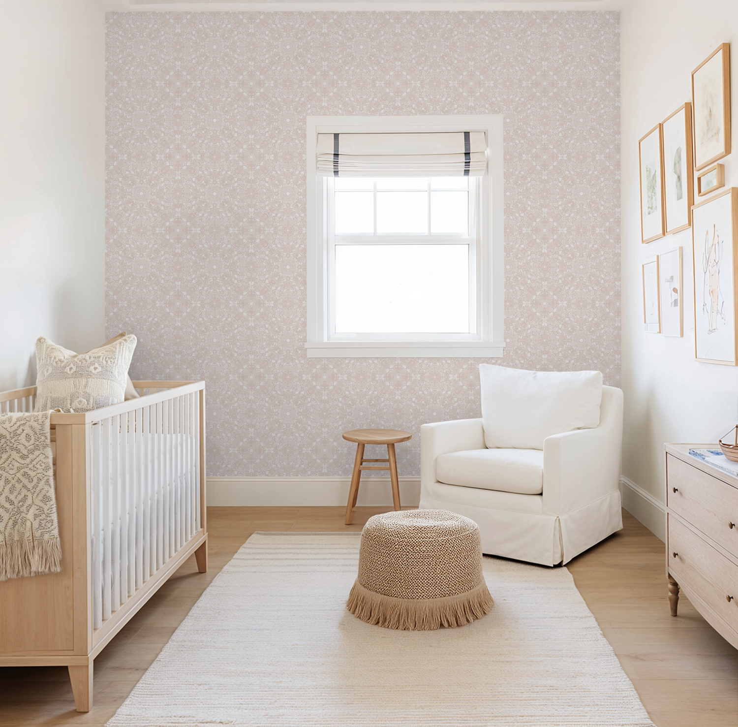 Wallpaper feature wall with a blush pink lacework mandala style pattern featuring hand drawn mushrooms, acorns and woodland creatures in a Nursery room with crib, armchair, and decorative elements.