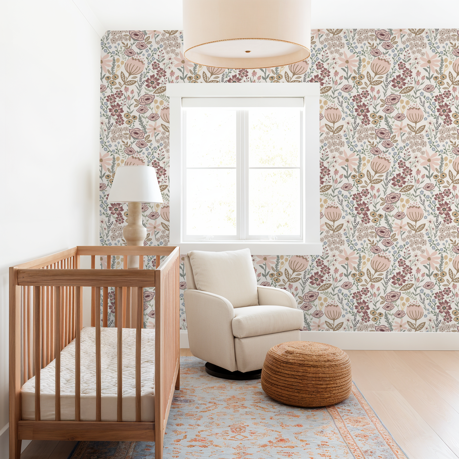 Nursery room with wooden crib, beige armchair, and floral wallpaper.