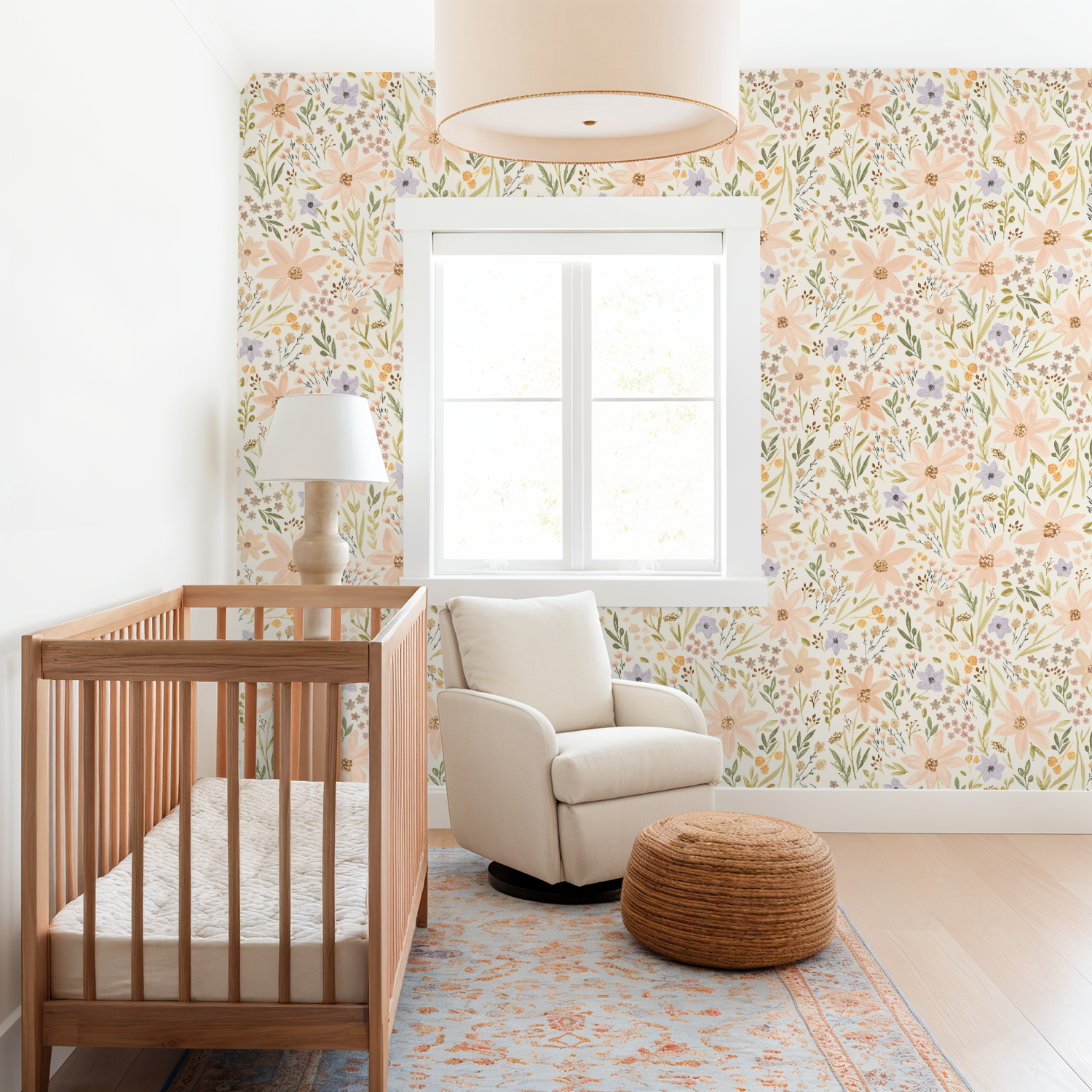 Nursery room with wooden crib, armchair, and floral wallpaper.