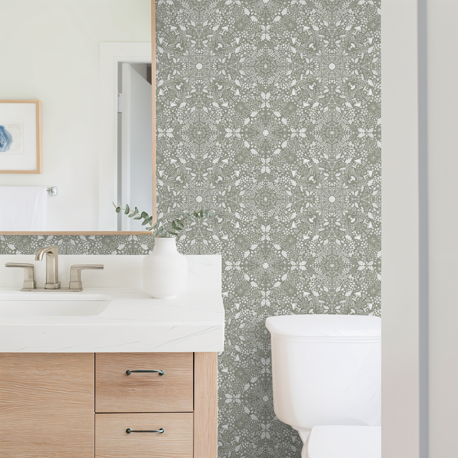 Bathroom with a Woodland Lace in Sage wallpaper, wooden vanity, and white toilet.