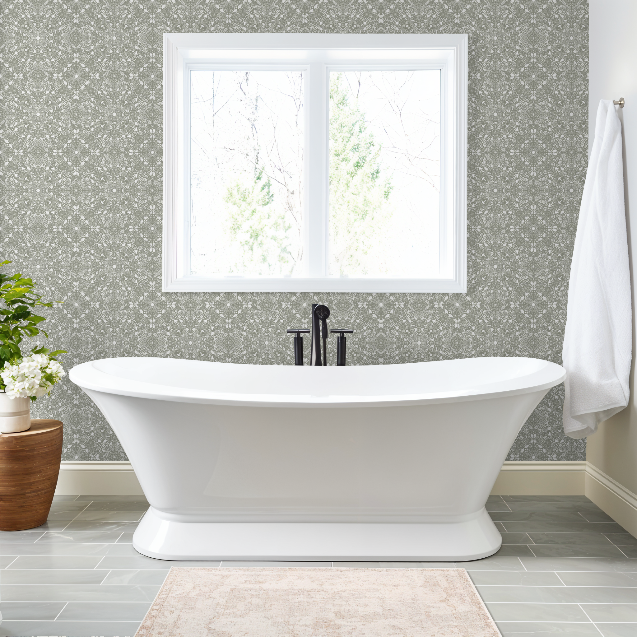 Bathroom with a freestanding bathtub, window, and a Woodland Lace in Sage wallpaper.