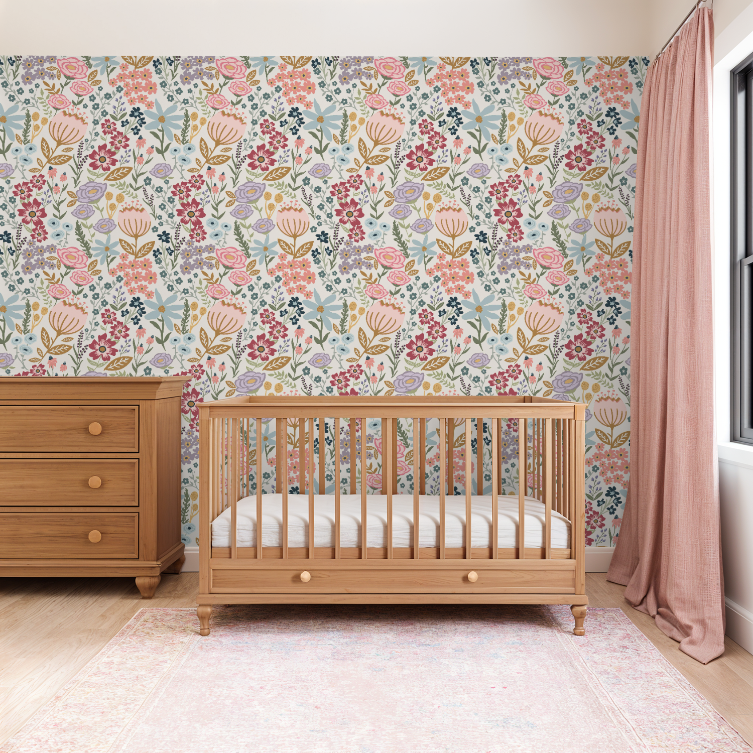 Nursery room with wooden crib and dresser against a floral wallpaper wall.