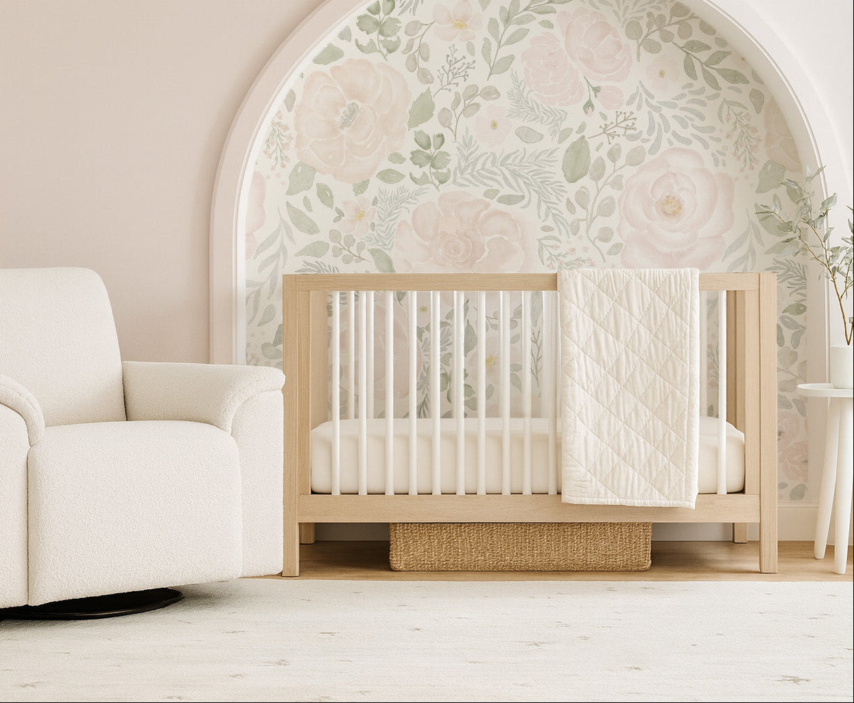 Arched nursery nook with Bella’s Blooms blush and sage floral mural, paired with a natural wood crib and cozy white glider for a serene, cottage-style space.