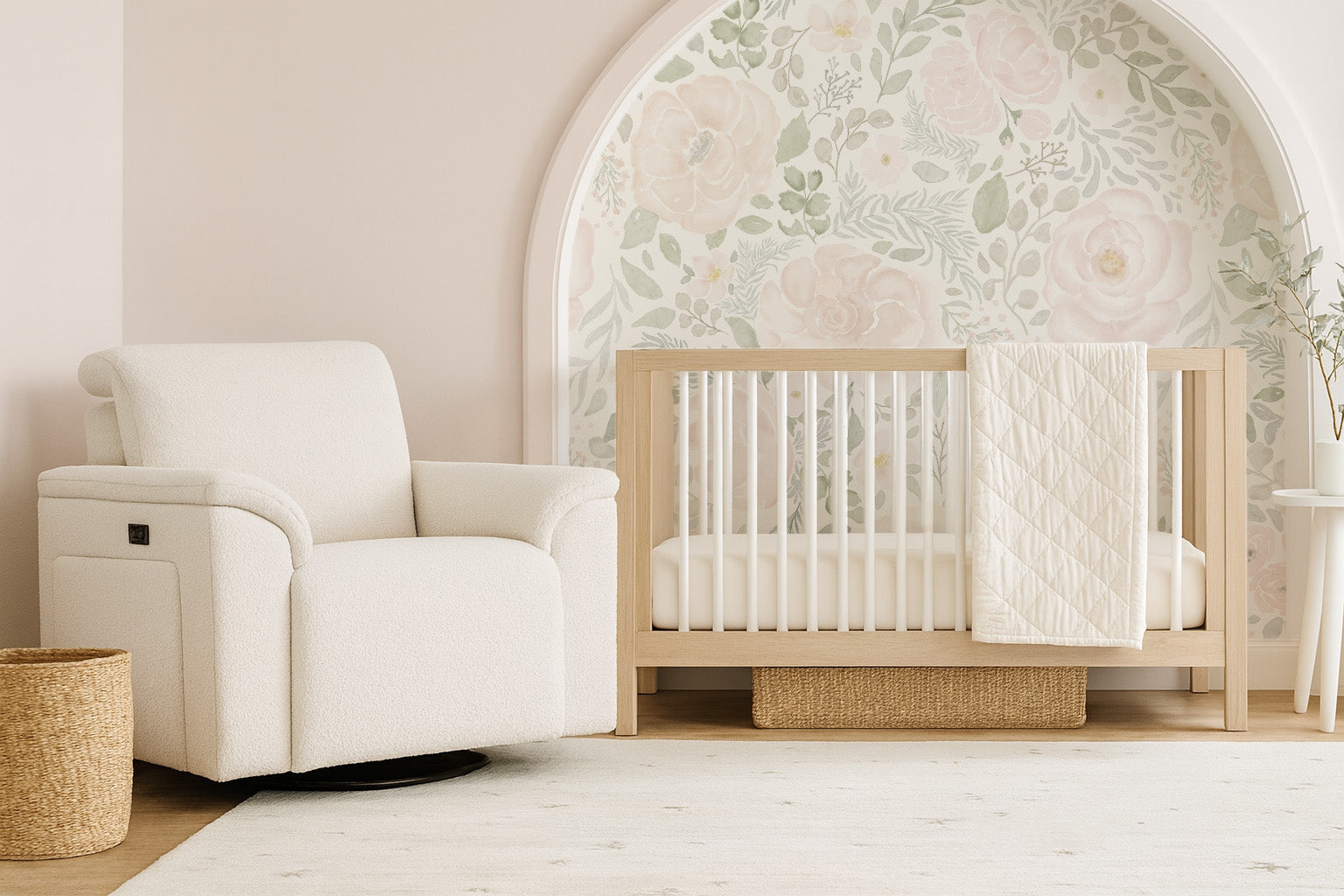 Arched nursery nook with Bella’s Blooms blush and sage floral mural, paired with a natural wood crib and cozy white glider for a serene, cottage-style space.