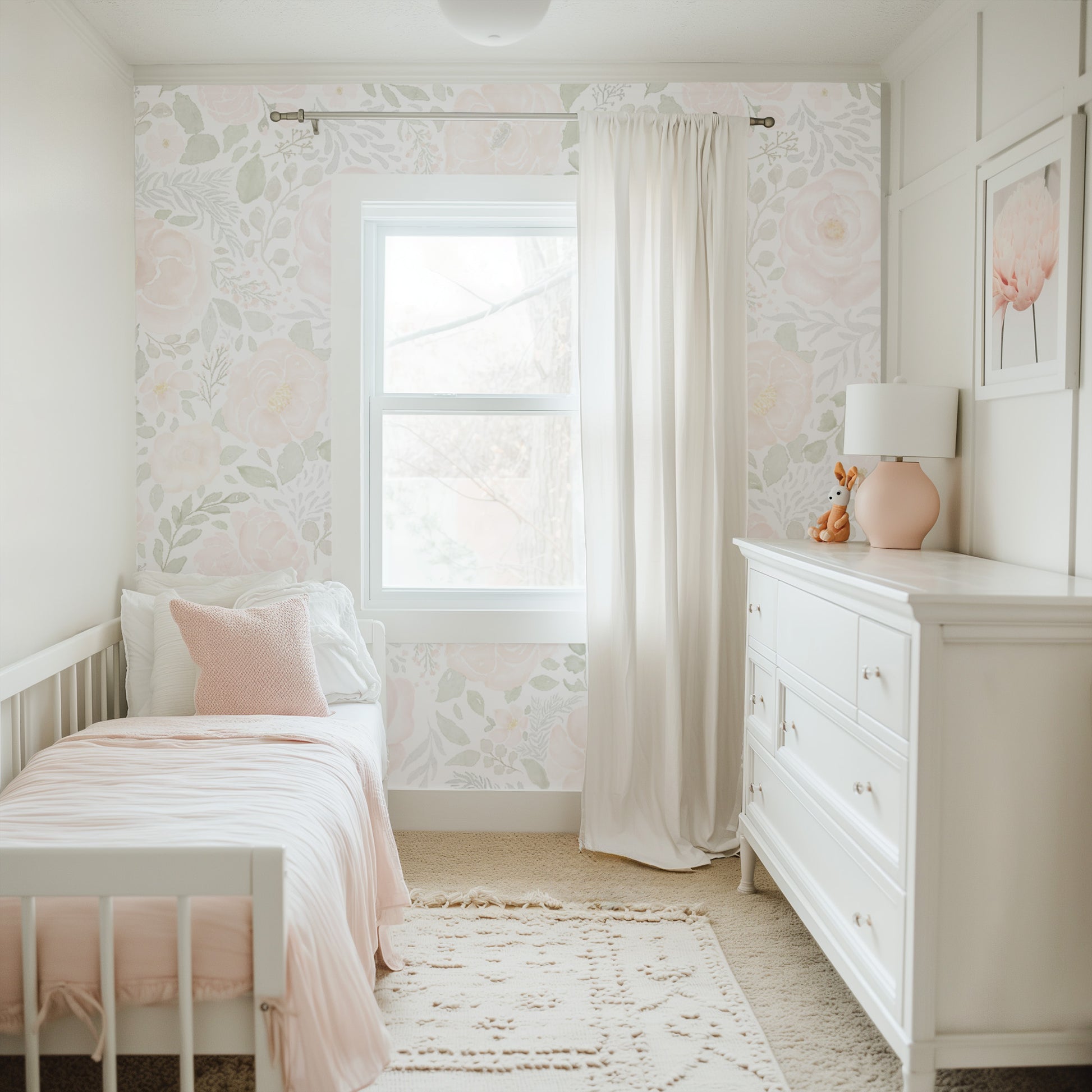 Children's bedroom with floral wallpaper, white furniture, and pink accents.