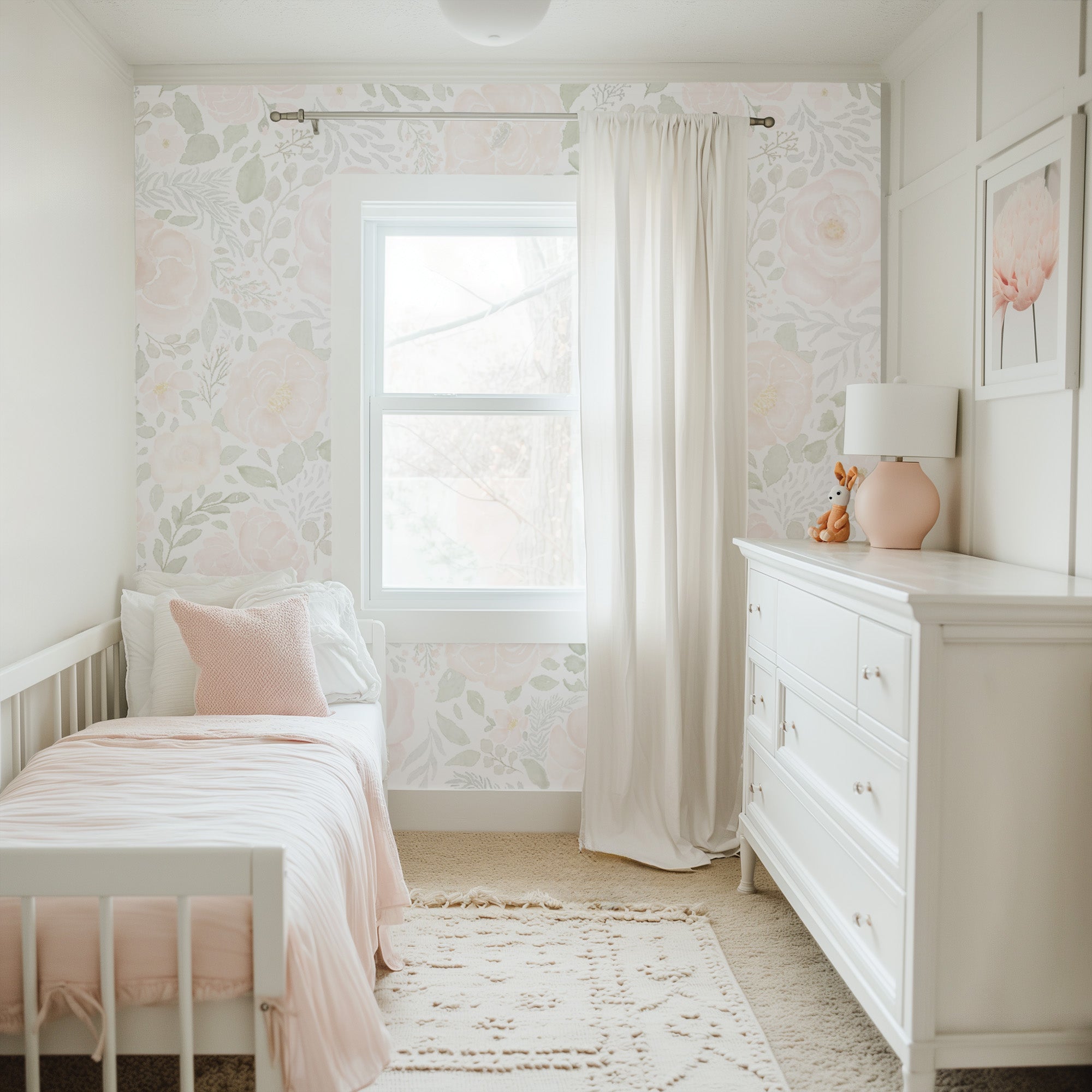 Soft blush and sage floral mural in a toddler room with a white crib, blush bedding, and light curtains, creating a gentle, whimsical sleep space.