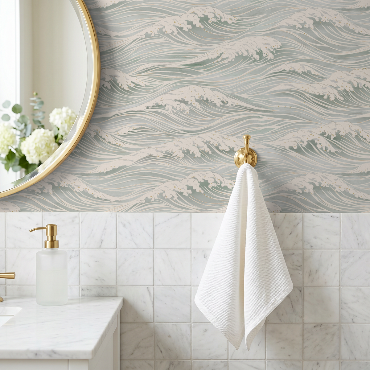 Blue ocean wave wallpaper with ivory whitecaps in a coastal bathroom with marble tile and brass accents.