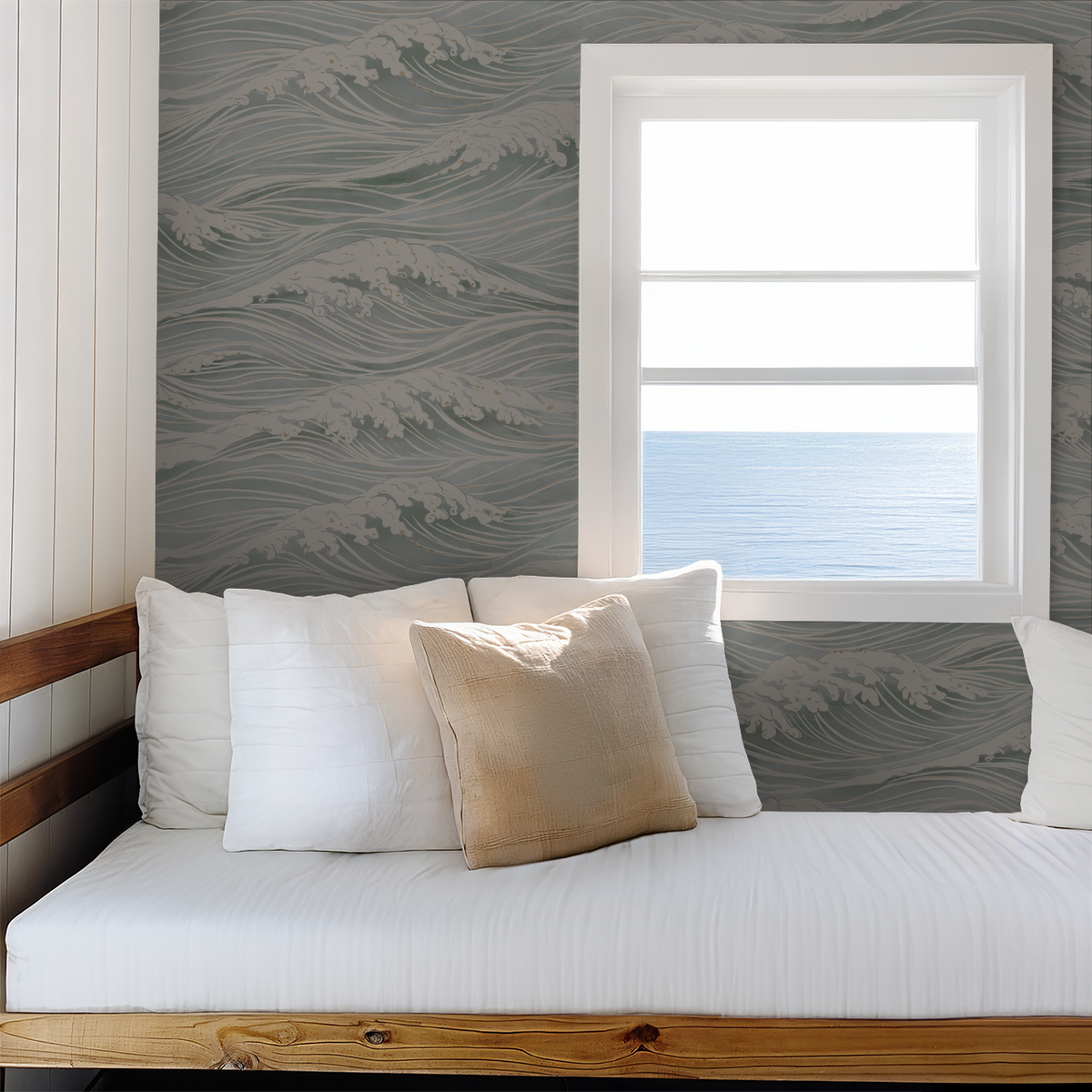 Blue and ivory wave wallpaper in a relaxed coastal bedroom with ocean view and white bedding.