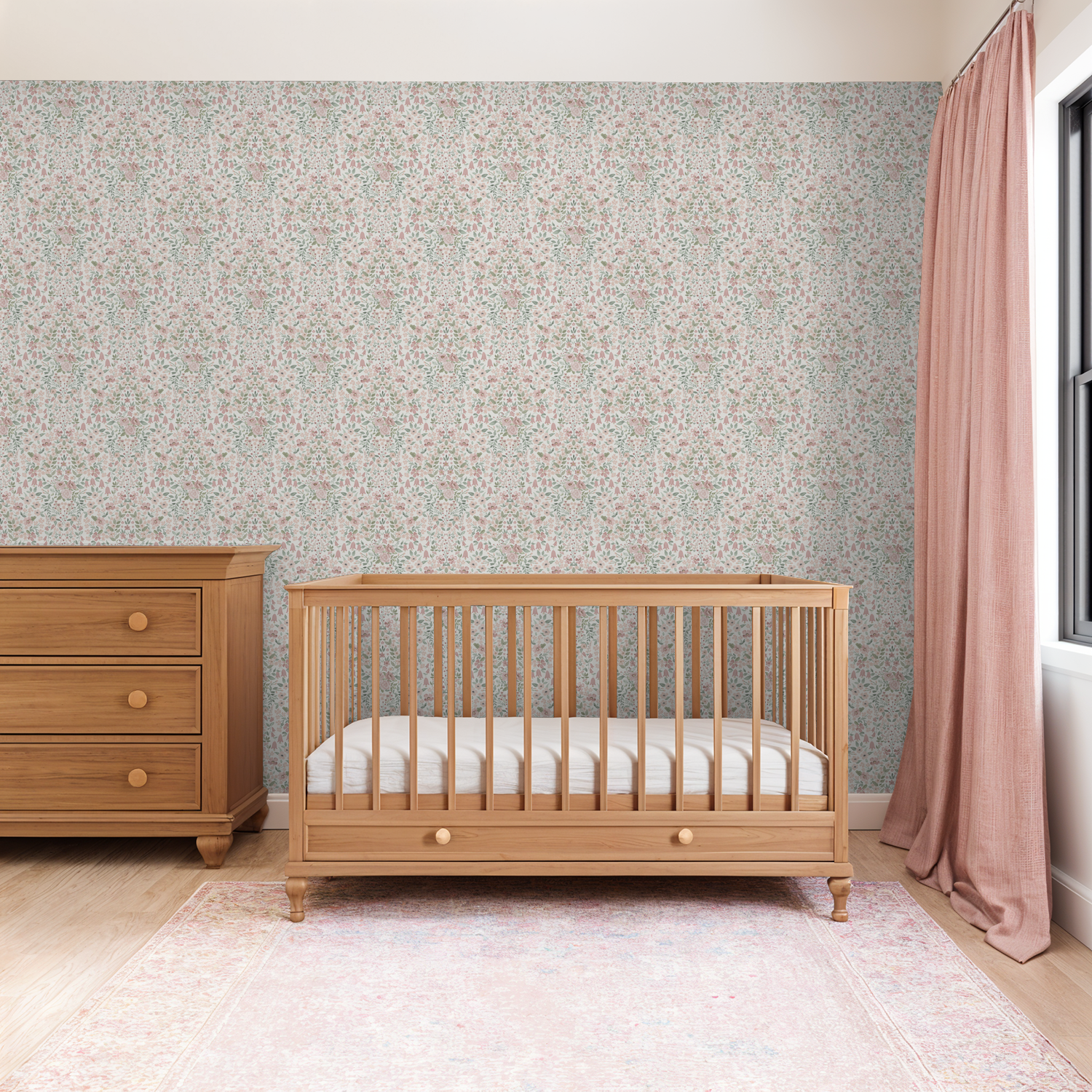 Neutral nursery with blush botanical wallpaper, oak crib, and warm wood dresser.