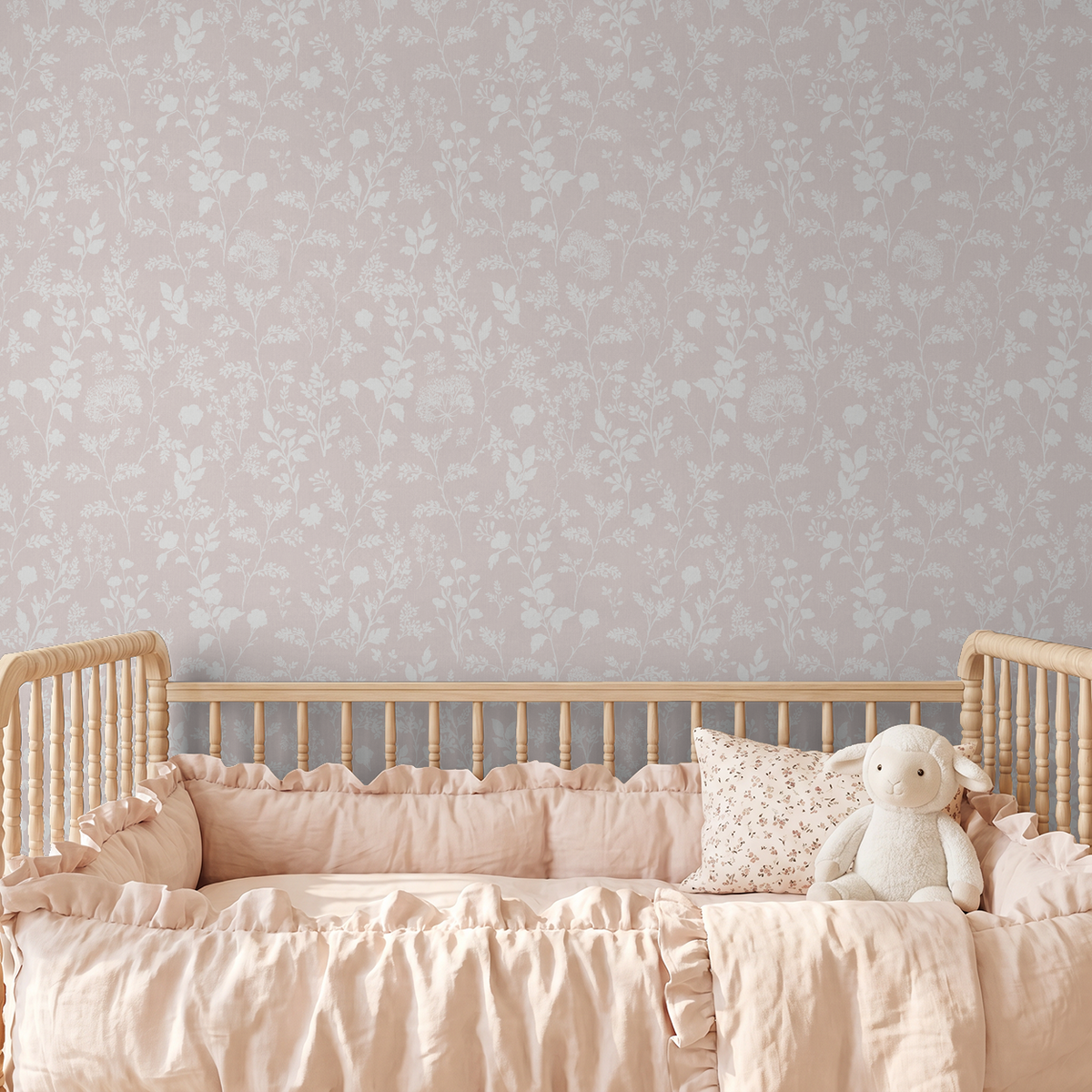 Blush floral wallpaper with botanical pattern in nursery with crib