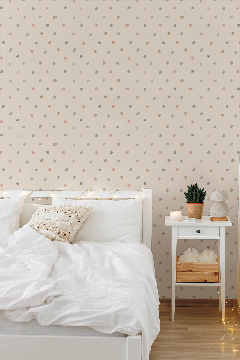 Bronte Dots pastel polka dot wallpaper in cozy bedroom with white bed and nightstand.
