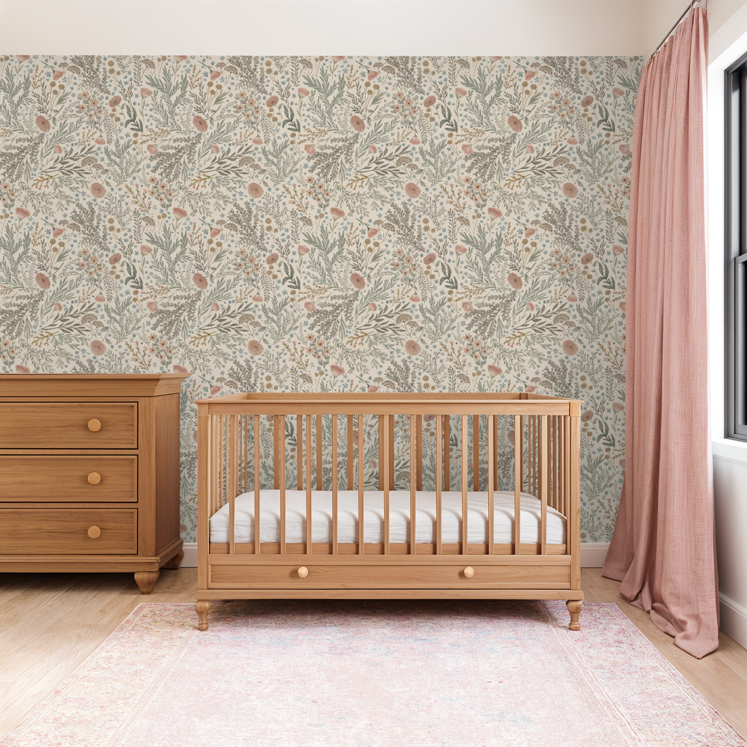Warm nursery with a natural wood crib set against Bronte Woodland Fauna Floral wallpaper in muted greens, blush tones, and soft botanical details.