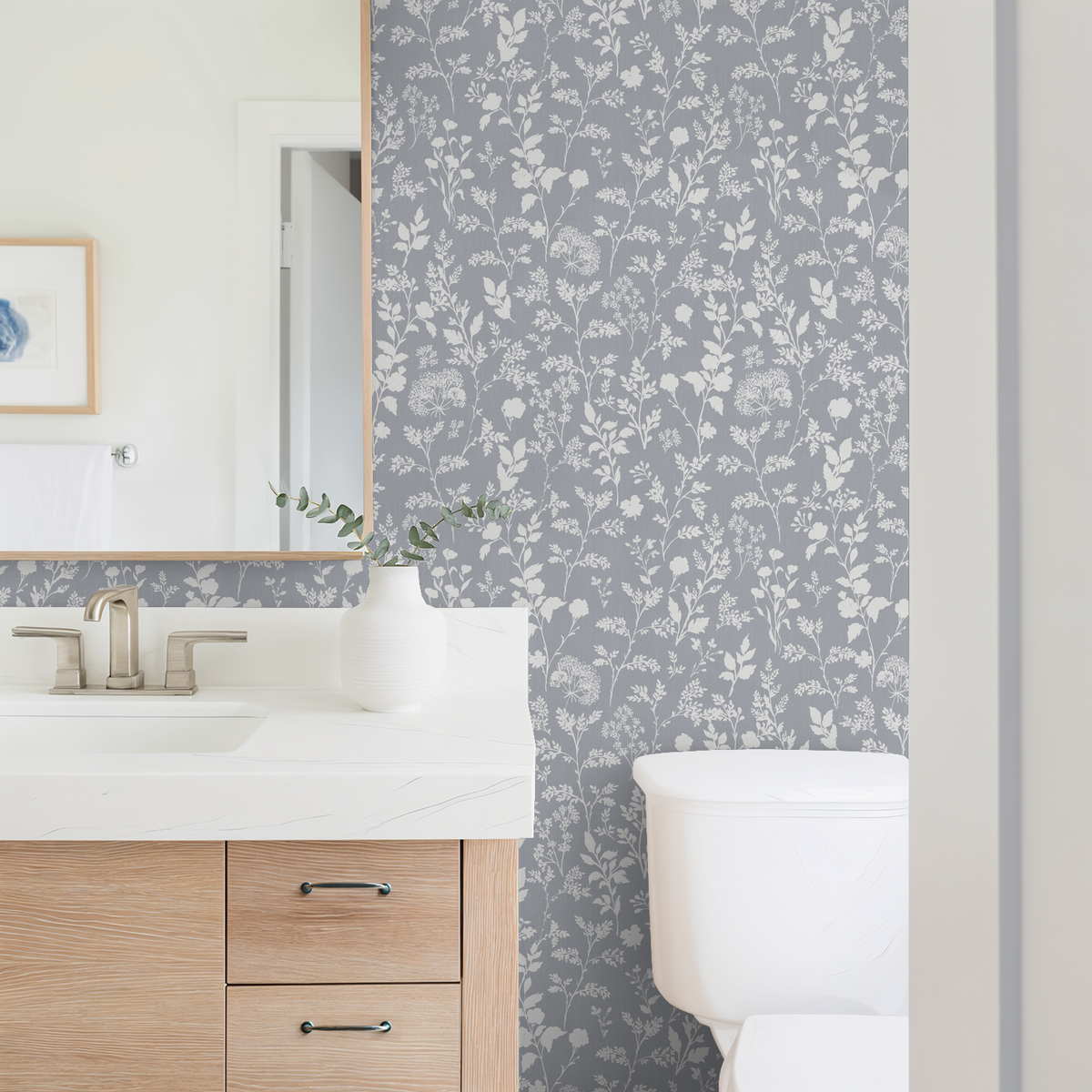 Chambray blue floral wildflower wallpaper in modern bathroom setting.