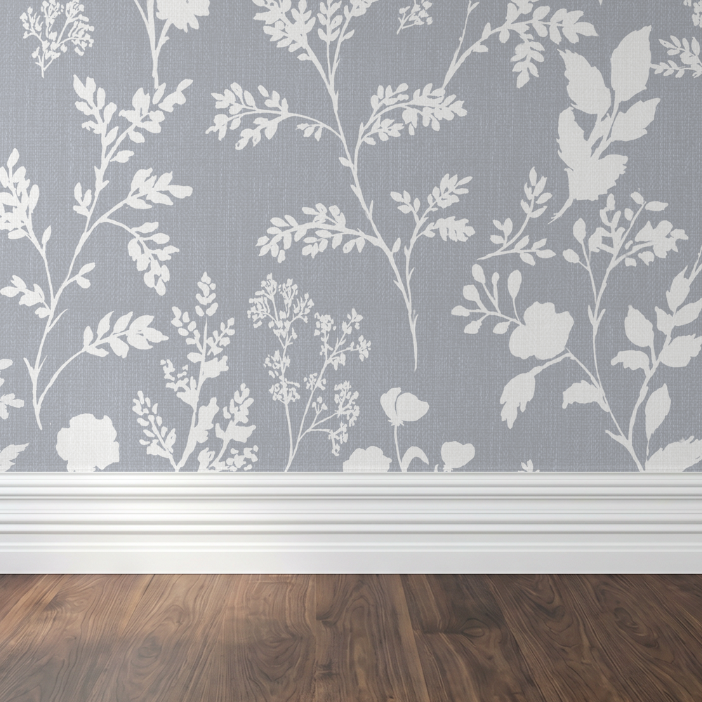 Chambray blue wallpaper with white wildflower botanical pattern in a room setting.