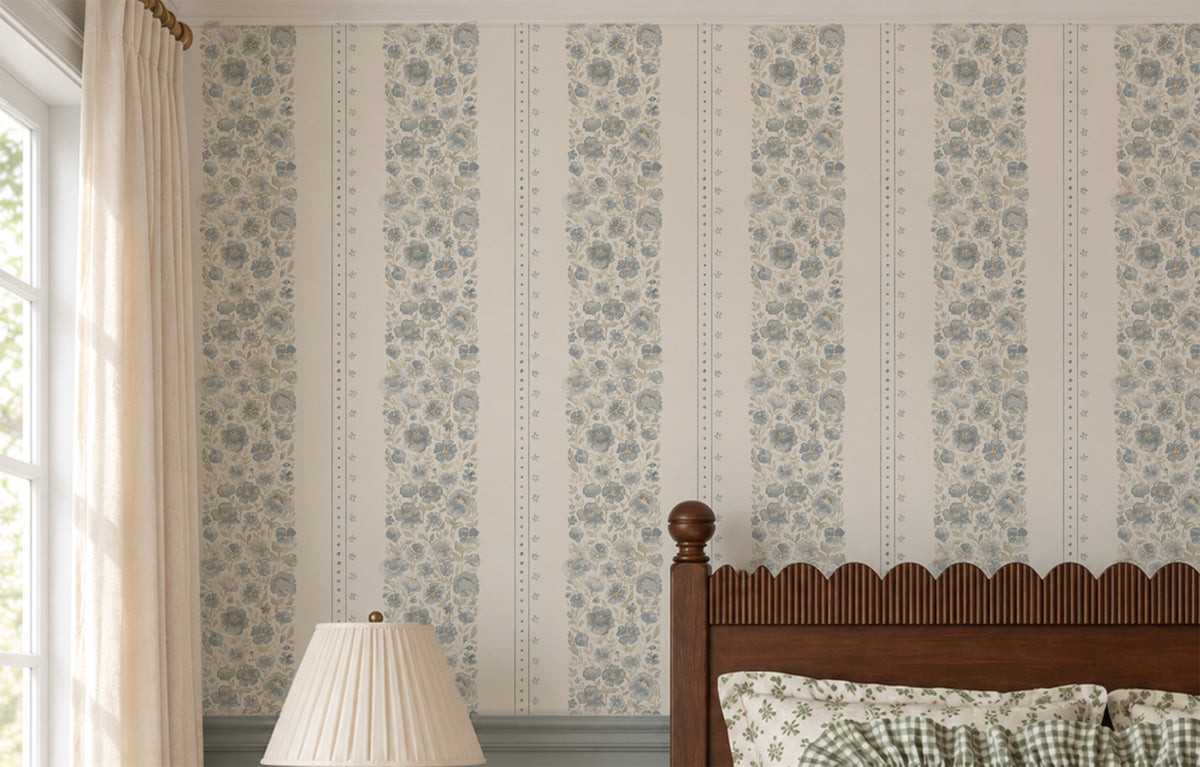 Chambray Cottage blue watercolor floral stripe wallpaper behind a dark wood bed with dusty blue millwork and soft neutral styling.
