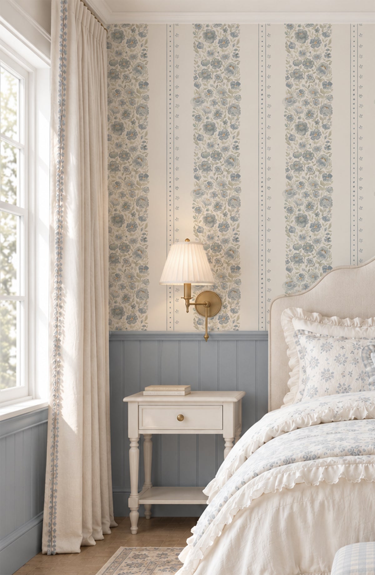 Chambray Cottage blue floral stripe wallpaper in a soft girls’ bedroom with dusty blue millwork, ivory bedding and brass sconce.