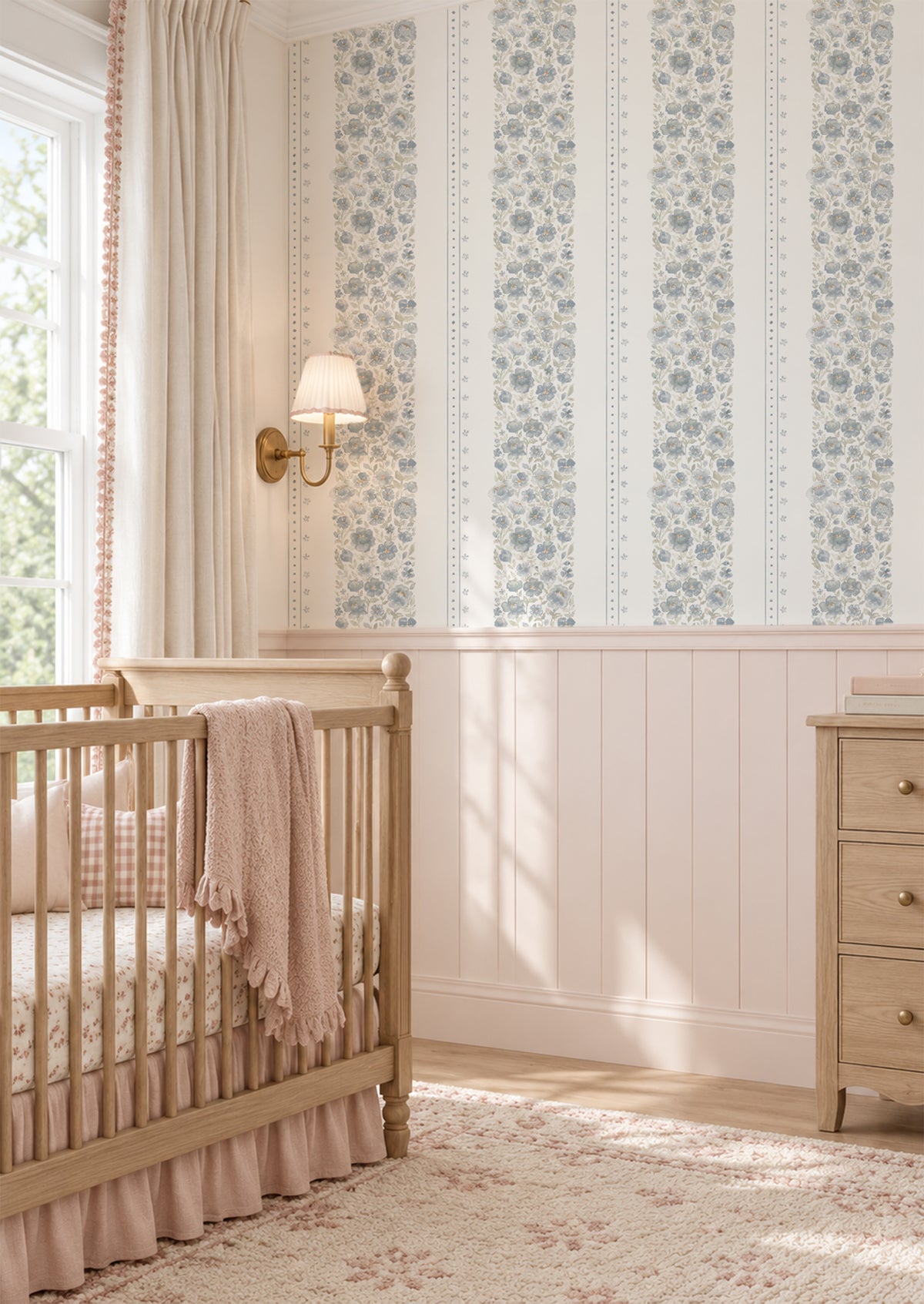 Chambray Cottage blue watercolor floral stripe wallpaper in a soft vintage nursery with blush millwork and a natural wood crib.