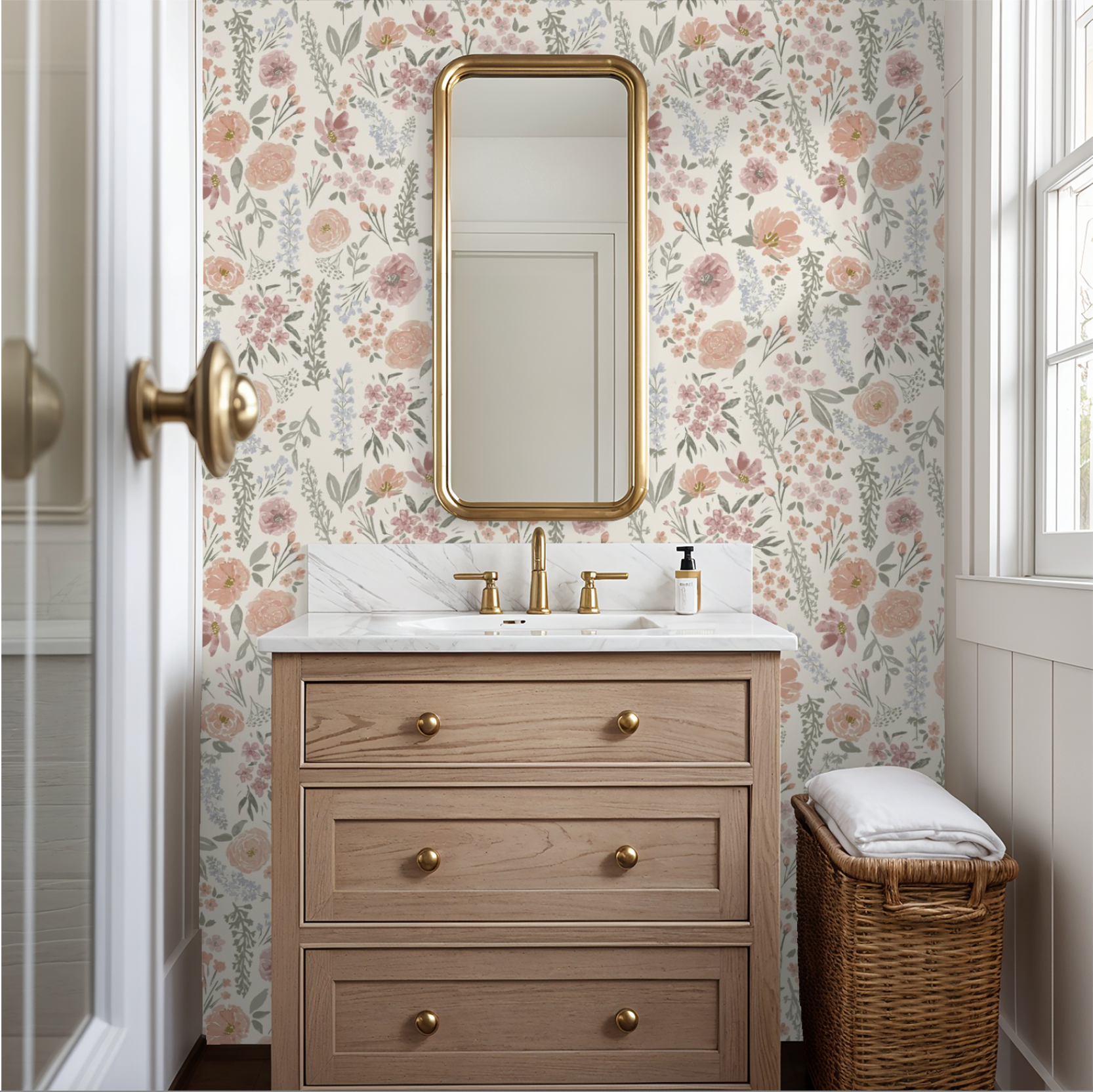 Blush peony and rose floral wallpaper installed in a powder room with gold mirror and wood vanity.