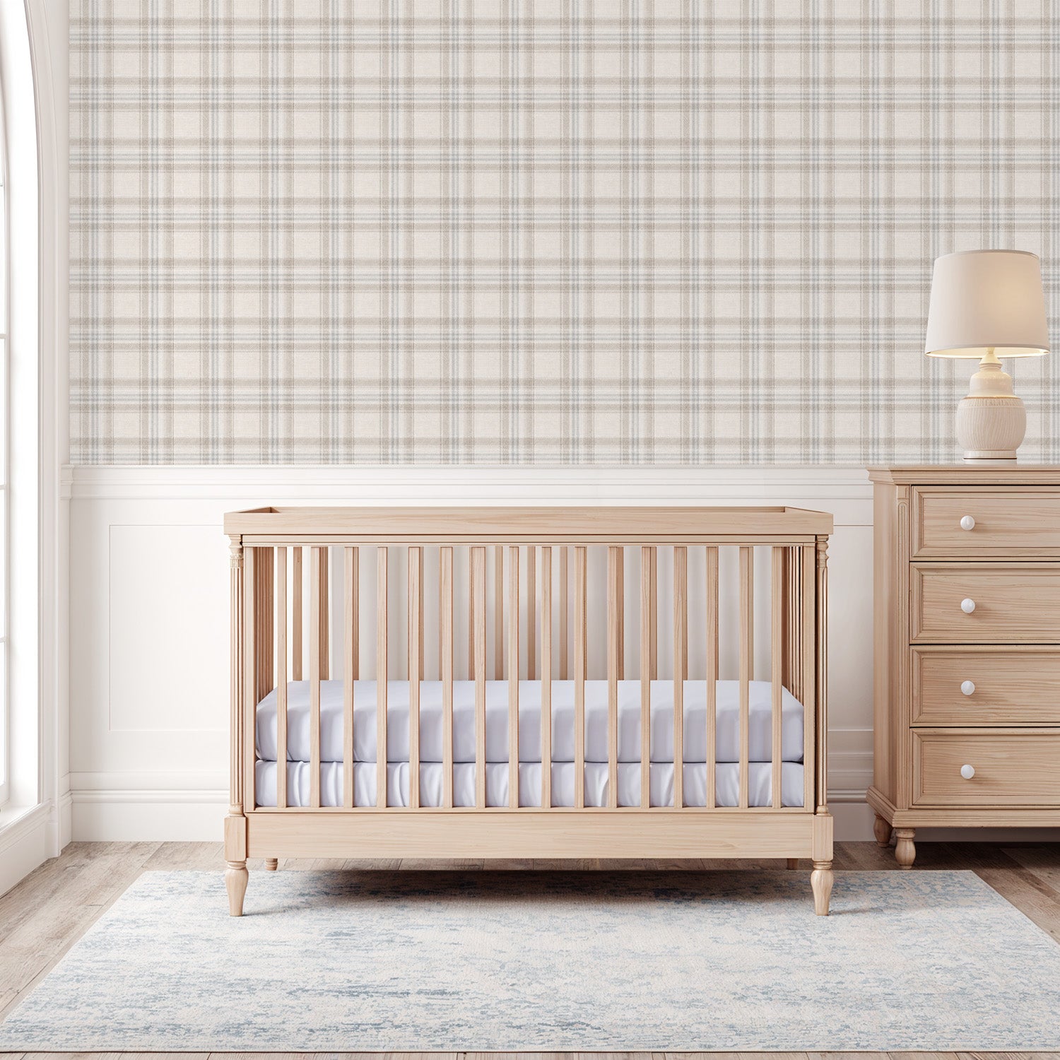 Nursery room with wooden crib and dresser against a Tweed Plaid  – Blue and Taupe wallpaper.