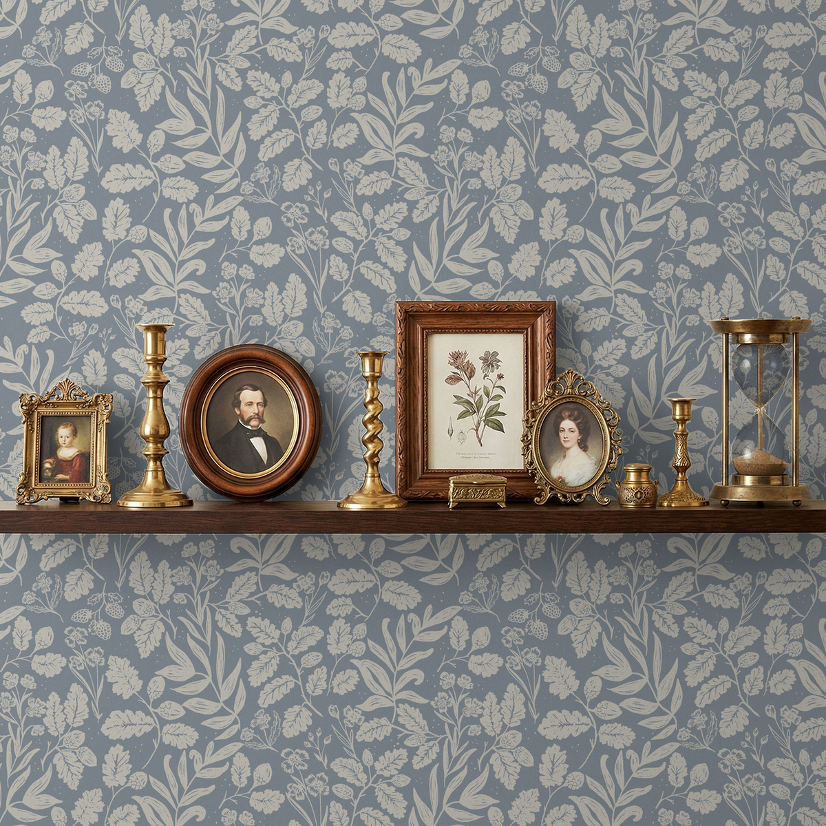 Dusty blue wallpaper with white oak leaves and acorns behind vintage decor on a shelf.