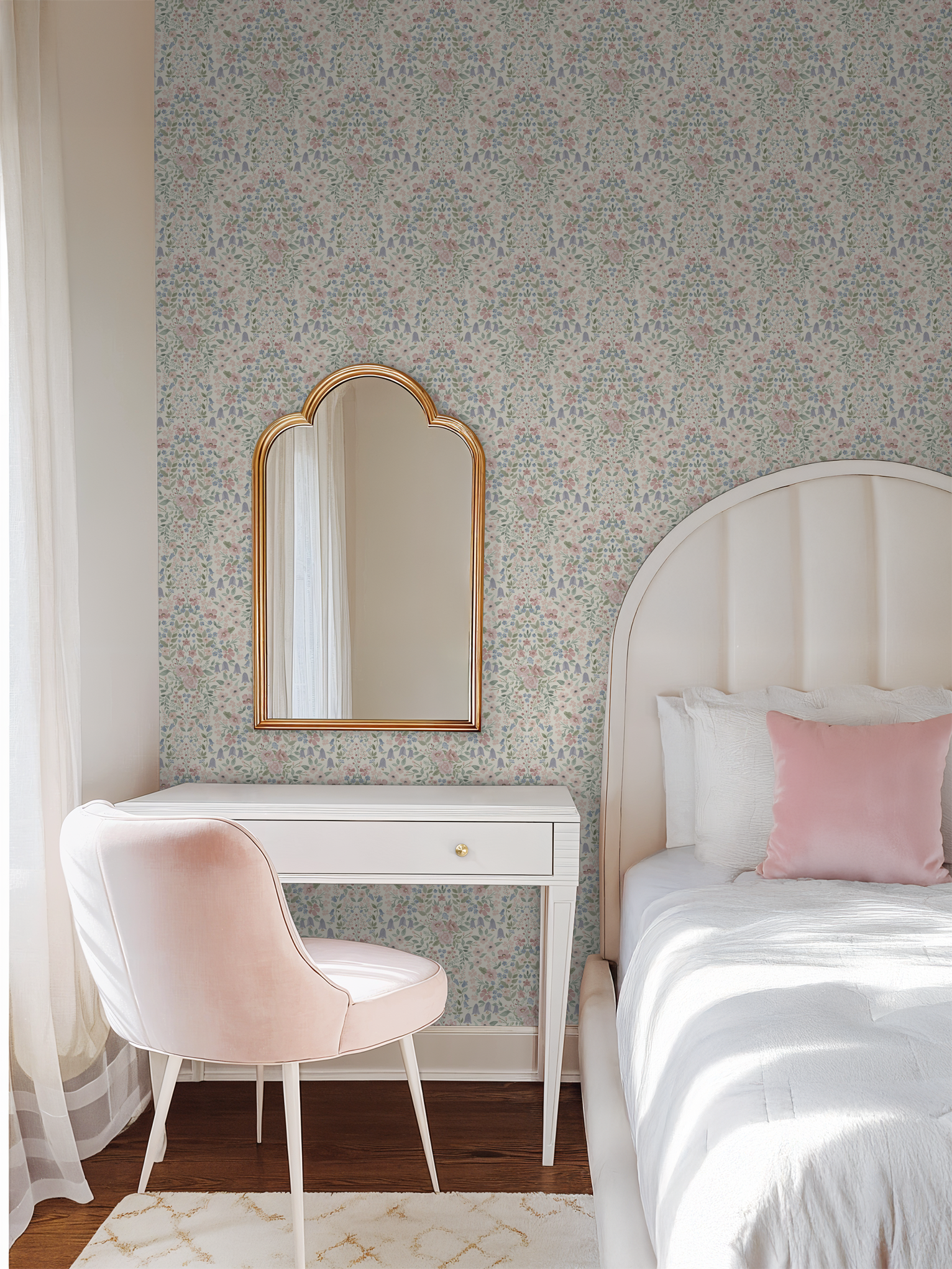 Elegant grandmillennial floral wallpaper in a feminine bedroom with gold mirror and blush accents.