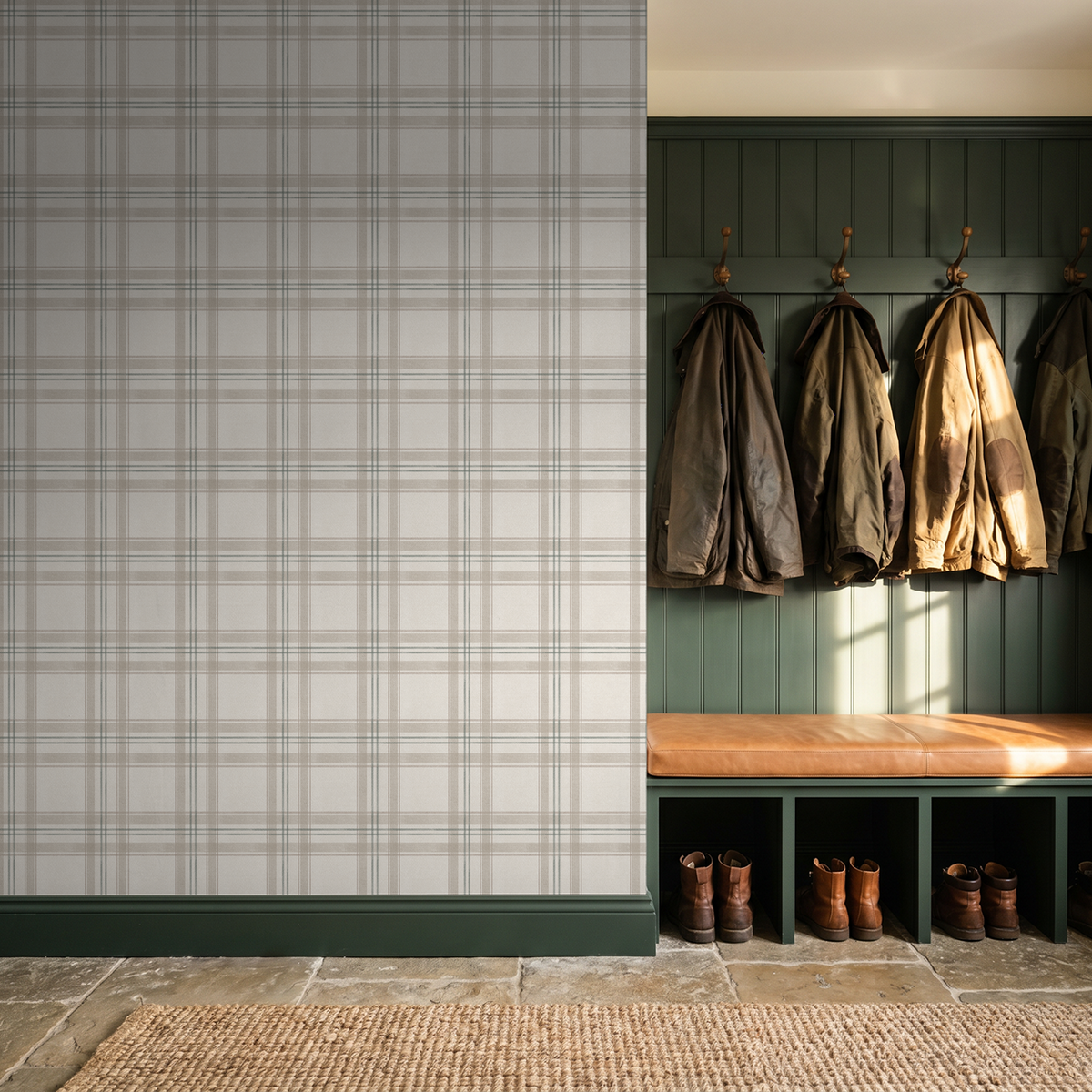 Green plaid wallpaper in rustic entryway with coats and boots.
